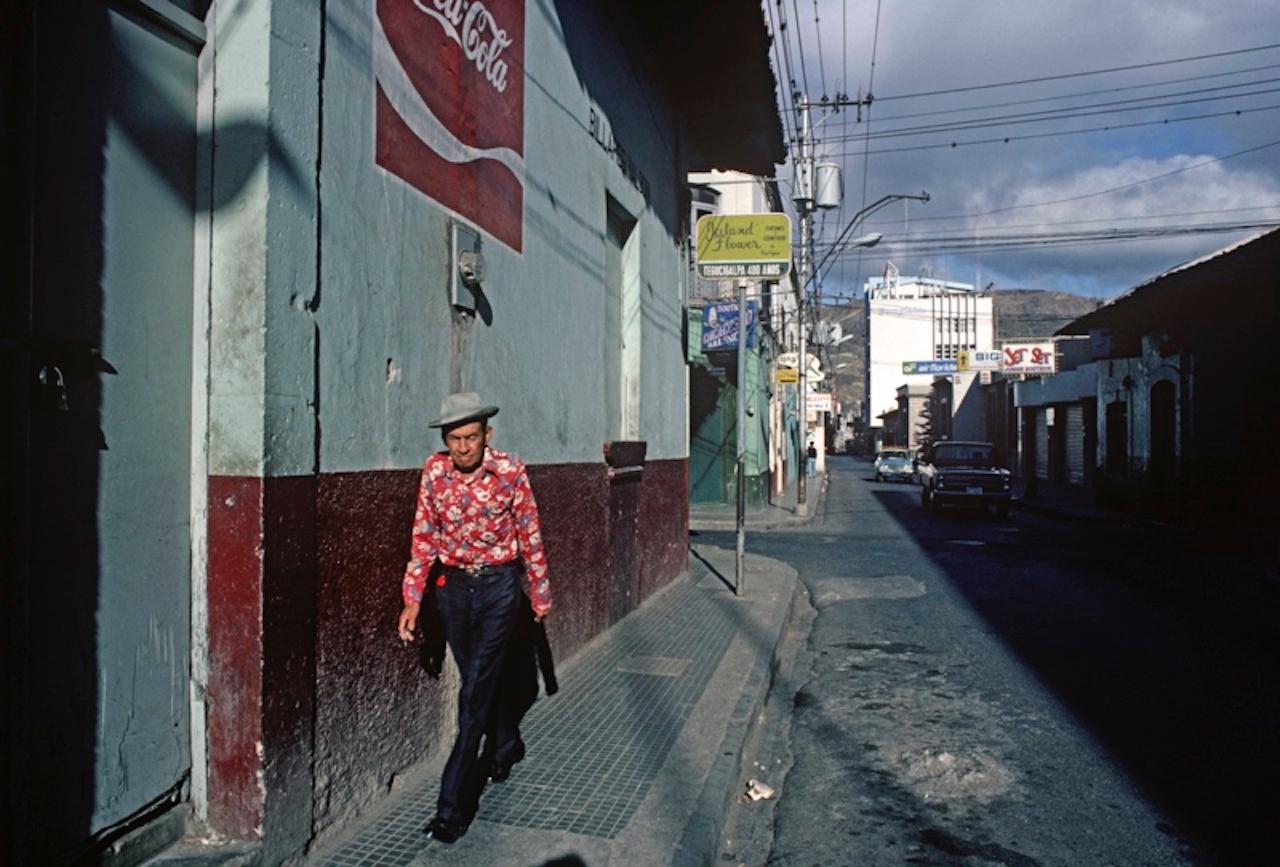 Tegucigalpa Street by Alain Le Garsmeur
Man walking down a street in Tegucigalpa, Honduras, Central America, 1981. 

Paper size 20 x 30 inches / 50 x 76 cm
Printed in 2022 - produced from the original transparency
Archival Pigment Print and limited