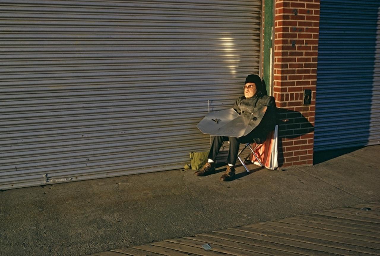 Winter Tan by Alain Le Garsmeur
Tanning with a sun reflector, Coney Island, Brooklyn, New York City, USA, February 1973. 

Paper size 20 x 24 inches / 50 x 60 cm
Printed in 2022 - produced from the original transparency
Archival Pigment Print and