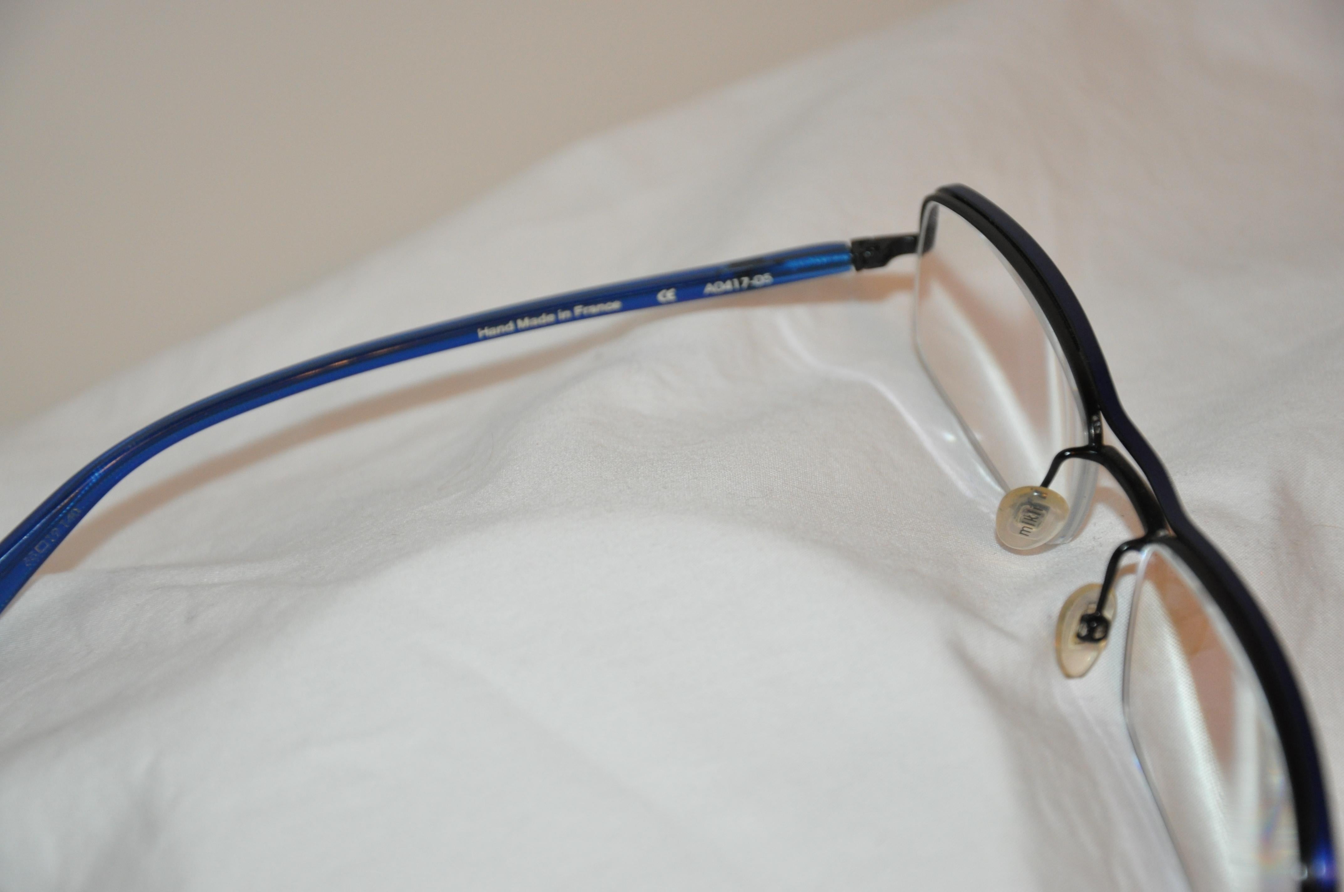 Alain Mikli of Paris wonderfully elegant Lapis-blue prescription frames are accented with black along the corners. Frames are of metal with lucid arms for comfort. Made in France, the front measures 5 1/4 inches across, the height measures 1 1/2