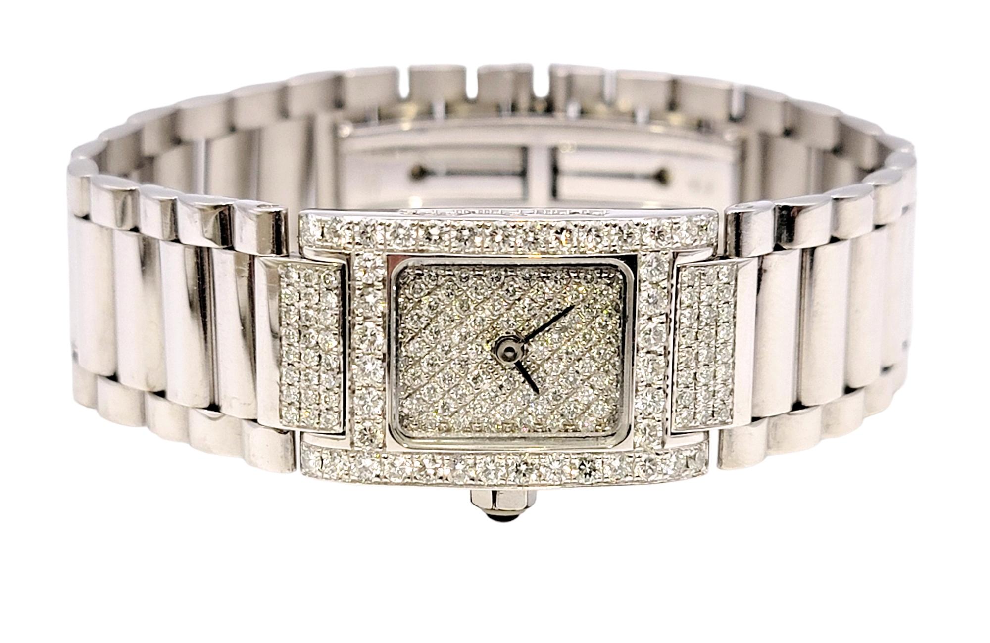 Exquisite designer wristwatch by Alain Philippe embellished with 2.00 carats of glittering icy white diamonds. The elongated rectangular diamond dial features steel hands, a manual wind and a round black cabochon on the crown. The flexible links are