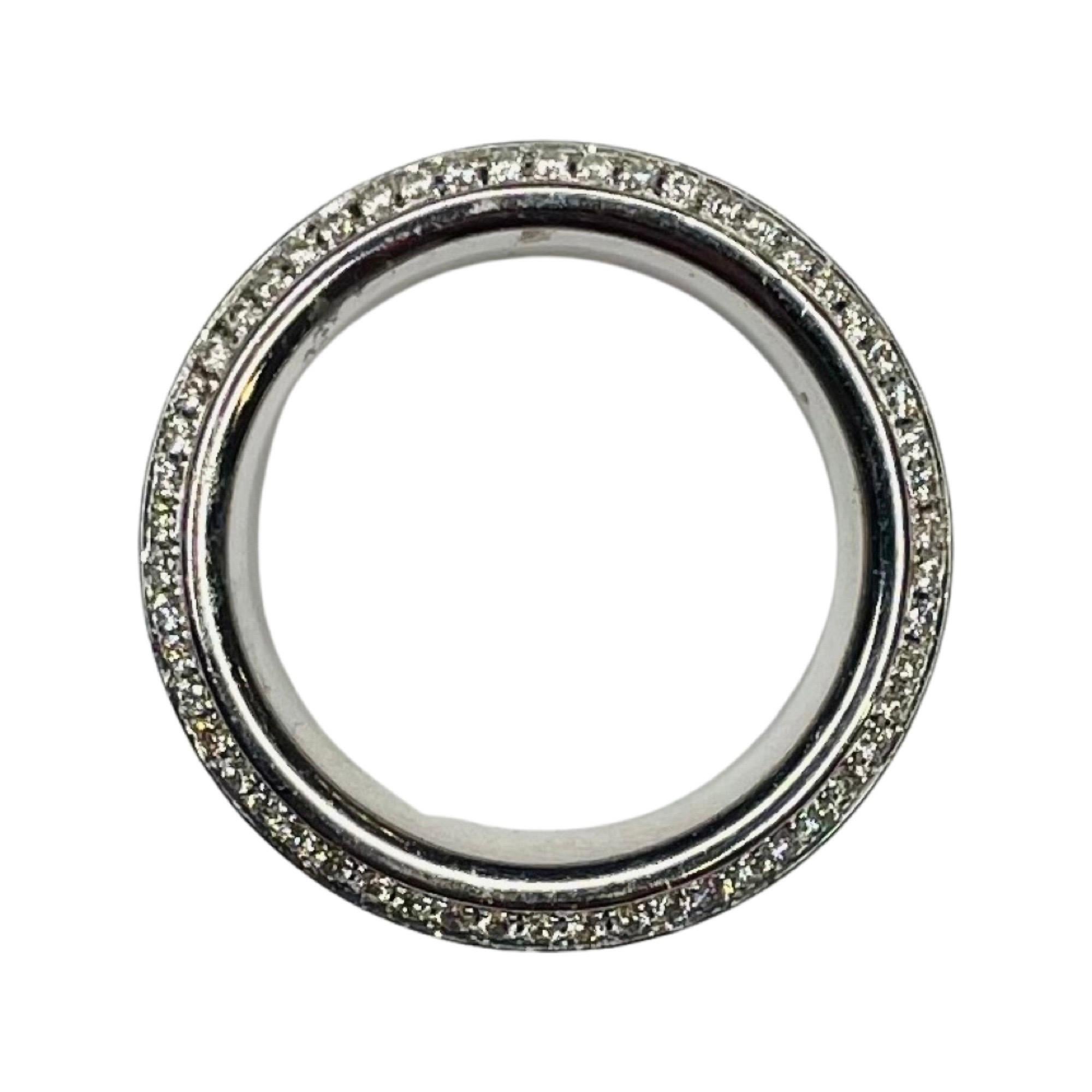 Alan Friedman 18K White Gold Sapphire and Diamond Eternity Band. There are 108 round brilliant cut diamonds of VS clarity and G color. There 0.75 carats total diamond weight. There are 123 diamond cut natural sapphires weighing 3.30 carats. The