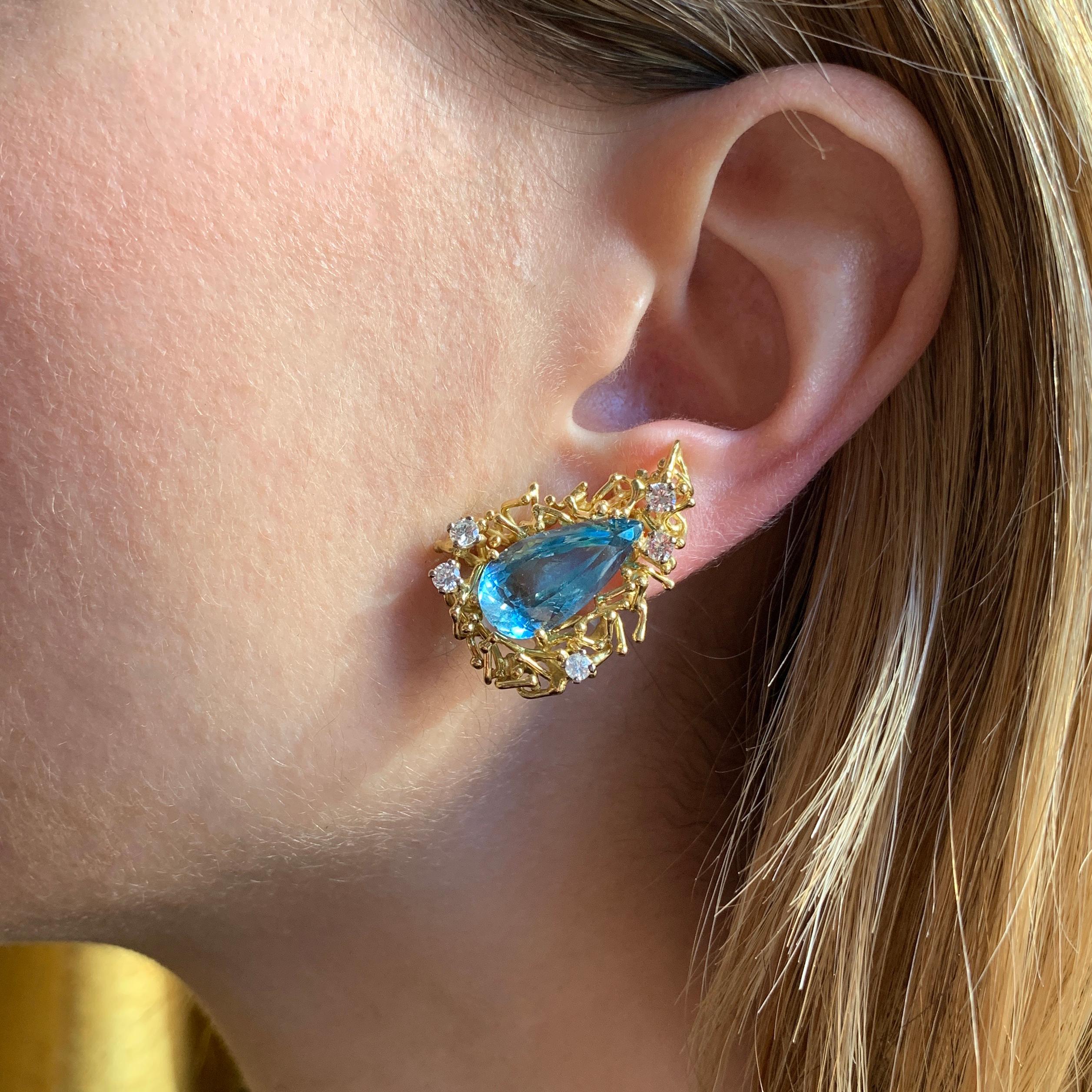 A chic pair of lfine, lustrous aquamarine, diamond, and 18k gold earrings, by Alan Martin Gard, 1968. These earrings light up the face and can be worn both day and night. A matching pendant is listed separately. 

Signed AMG. Stamped 750. London