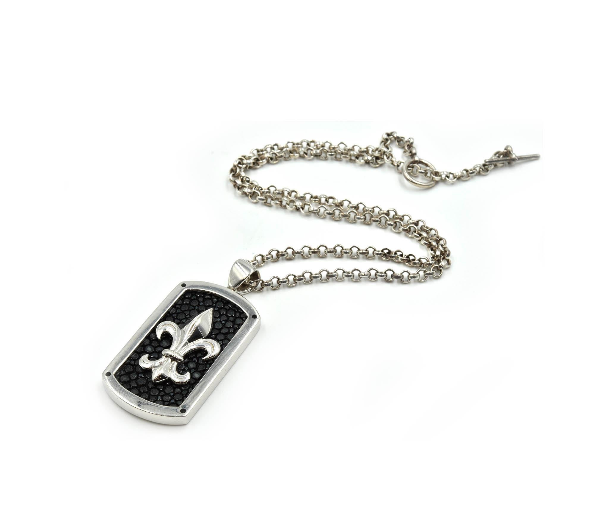 Designer: Alan K
Material: sterling silver
Dimensions: Fleur-de-Lis dog tag measures 2 inches long and 1 inches wide, necklace measures 18 inches long
Weight: 33.00 grams
Retail: $300
