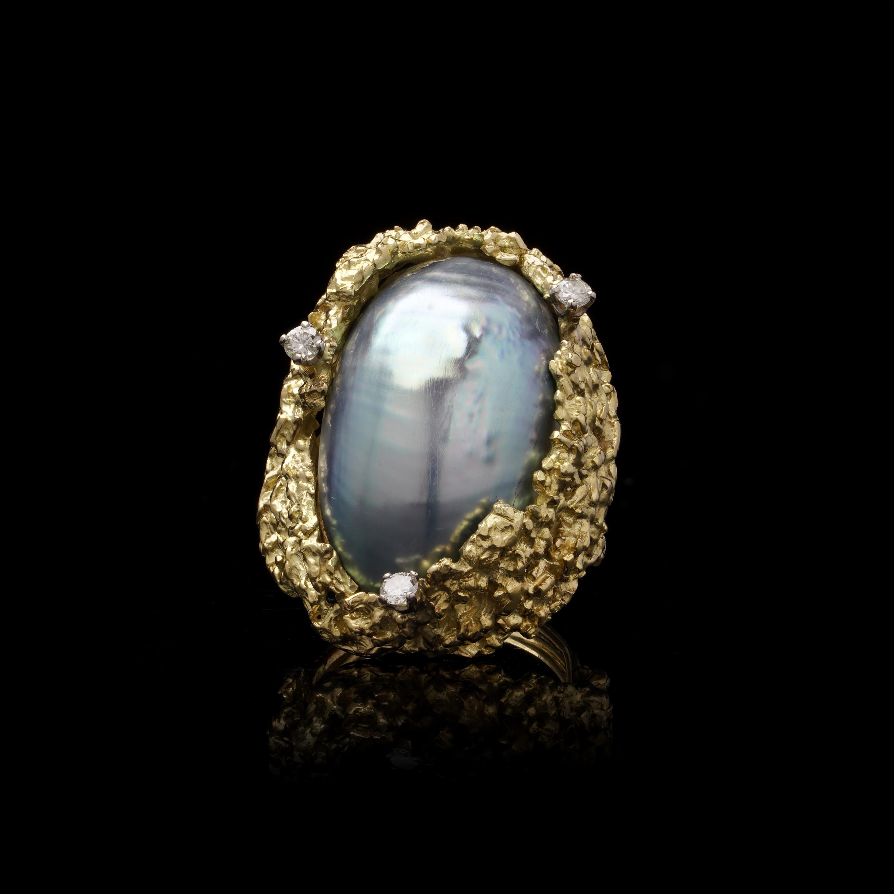 Alan Martin Gard Blister Pearl and Diamond Ring, 1966

This distinctive vintage ring from Alan Martin Gard features a unique blister pearl set in a textured 18kt gold band, accented by three diamonds. Fully hallmarked with English marks and the