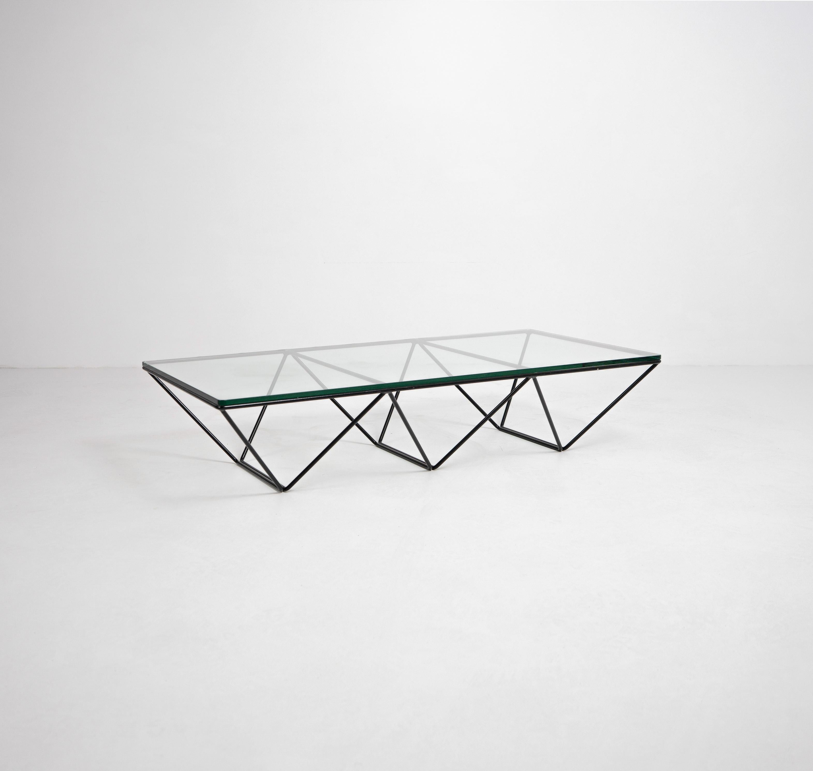A rectangular 'Alanda' coffee table designed by Paolo Piva and produced by B&B Italia, c.1980. Composed from a minimalist iron base of geometric form and a thick glass top. 

Dimensions (cm, approx):
Height: 26
Width: 120
Depth: 60