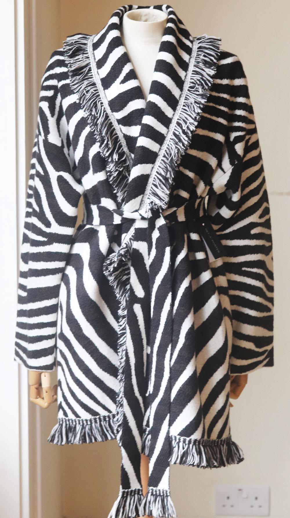 Alanui's 'Lapponia' cardigan took a total of eight hours to be knitted, plus another six for assembly and finishing, it's been made in Italy from zebra-jacquard wool and detailed with bohemian fringing. Black and white zebra-jacquard wool. Tie