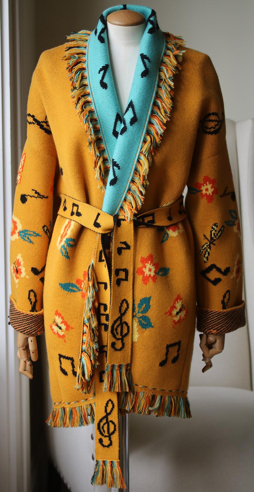 This multicoloured Alanui Musical note cashmere belted cardigan is crafted from cashmere in Italy, with a musical note and floral motif, fringed trim, removable knit belt, slip pockets and guitar motif to the back with the slogan, ‘I wanna be a