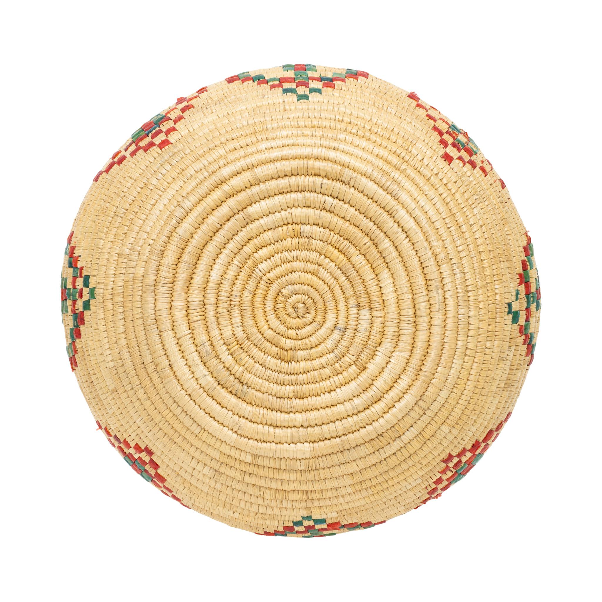 Alaskan lidded basket. With beautiful green and red diamond design around body, mirrored on lid. Design with some losses. Still a highly displayable piece, great for a coastal cabin or a handmade indigenous basketry collection. First half 20th