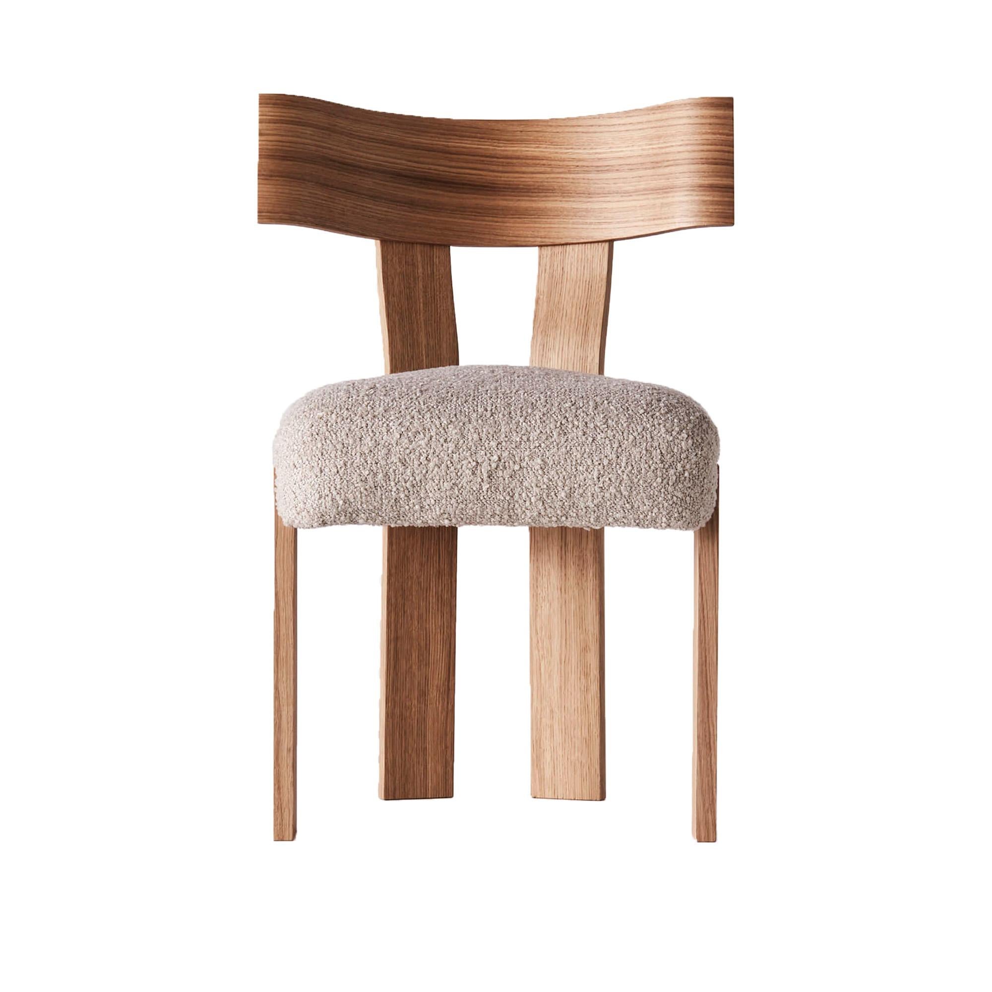 The Alba Chair features a chunky, yet elegant shape that brings both character and sophistication to any space. Its base is crafted from solid oak and consists of straight, angular legs paired with a beautifully curved, generous backrest that