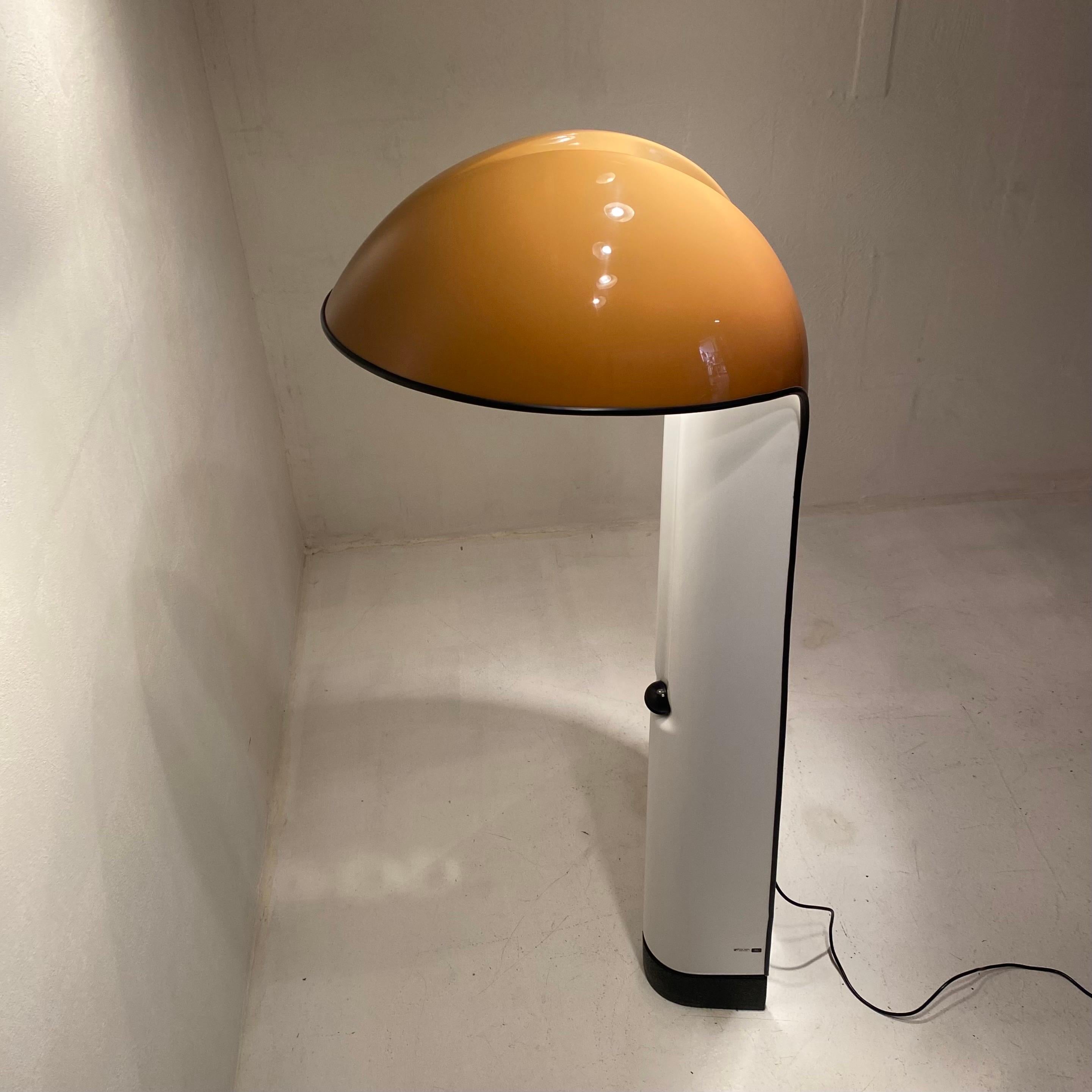 Rare and iconic Italian floor lamp, Alba, meticulously designed by Ermanno Lampa and Sergio Brazzoli for Guzzini in the 1970s. 

Crafted with caramel-colored plastic on the exterior and pristine white on the interior, this original masterpiece