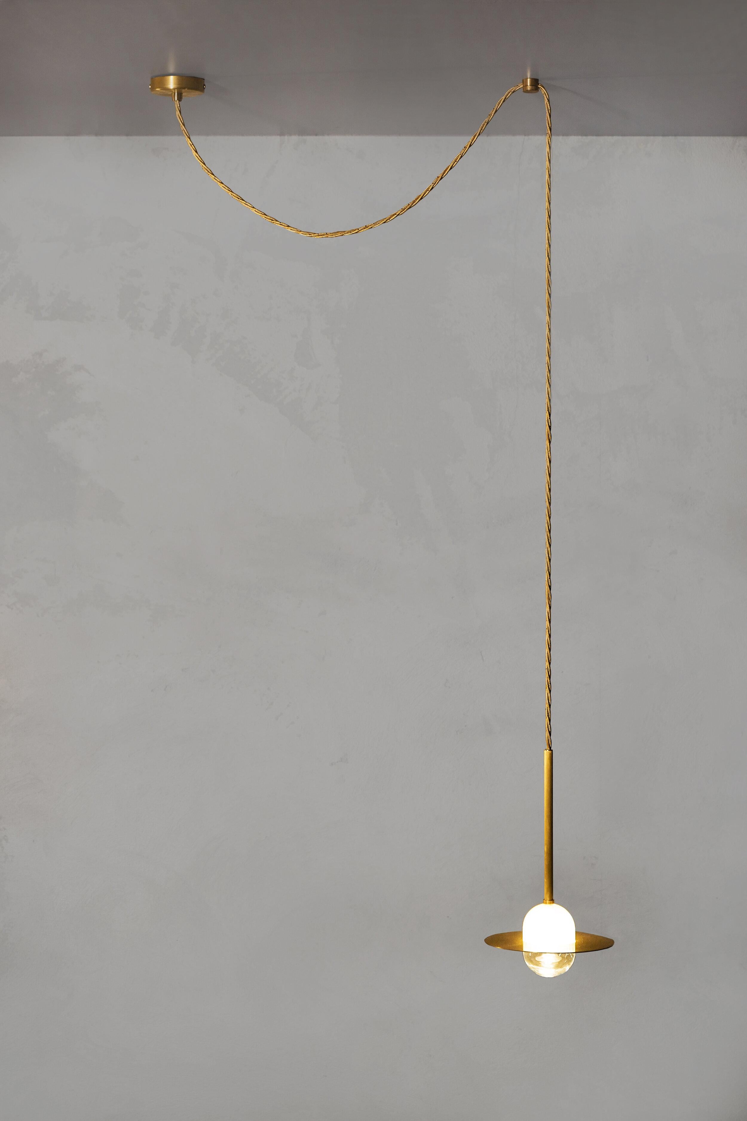 Alba pendant cable by Contain.
Dimensions: D 15 x W 15 H 100 cm (custom lenght).
Materials: brass, 3D printed PLA structure and optical lens.
Also available in different finishes.

All our lamps can be wired according to each country. If sold