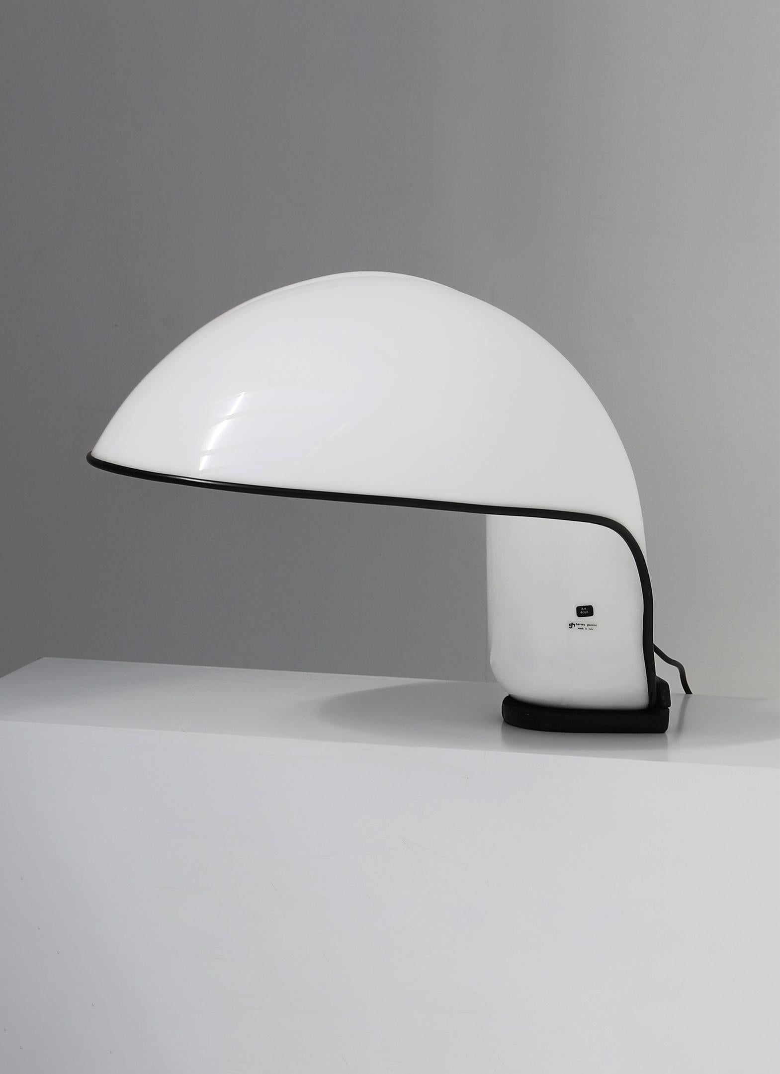 Albanella table lamp designed by Sergio Brazzoli and Ermanno Lampa in 1973 for Harvey Guzzini. This space age sculptural lamp attests the design of the 1970s with its sleek futuristic design and materials. The lamp is made out of a white plastic