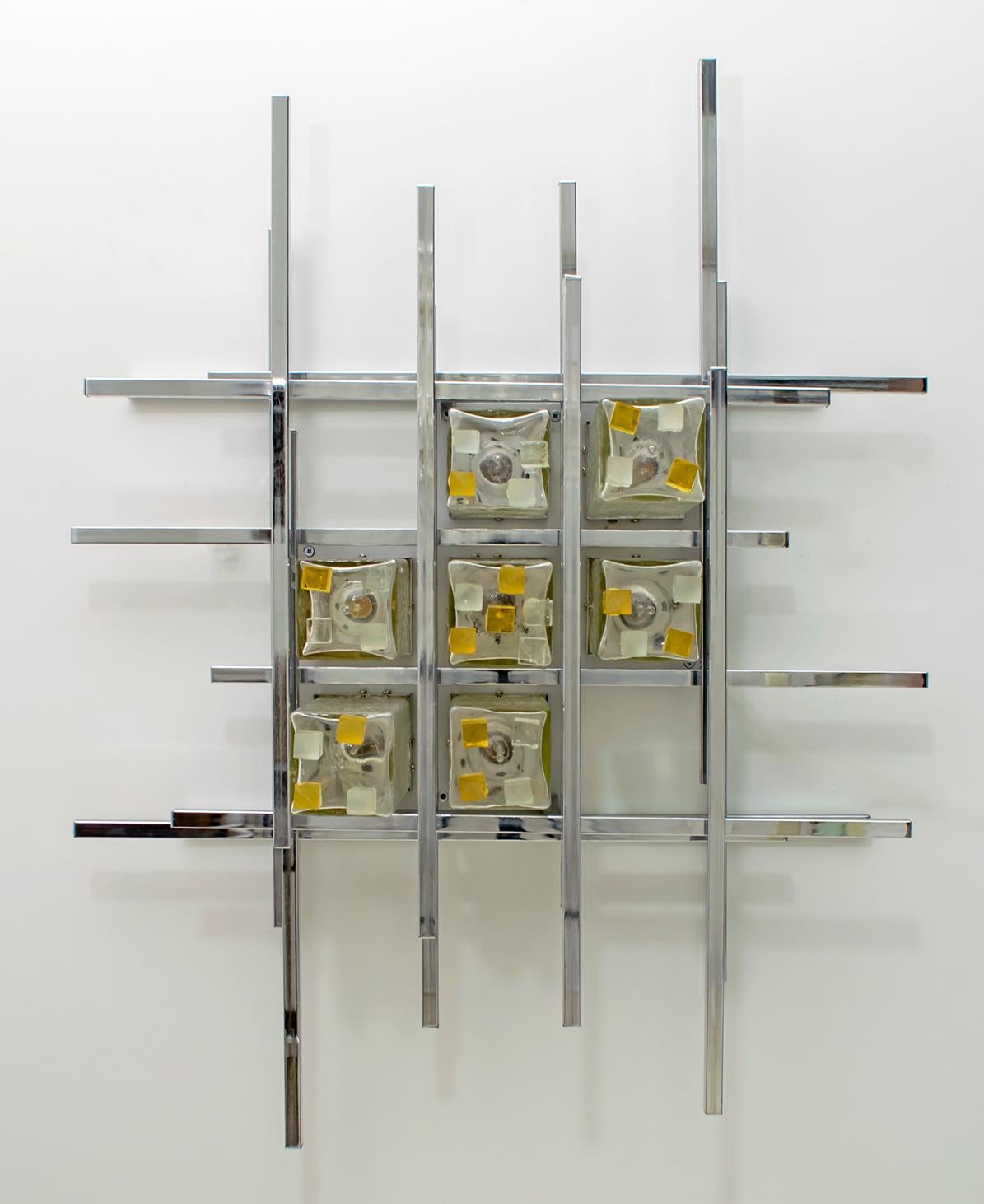 This wall lamp was created by the master glassmaker Albano Poli for his company Poliarte. Wall lamp with rectangular chromed metal rods and clear Murano glass cubes mounted on aluminum plates, to create a unique sculpture, circa 1970s.

Poliarte: