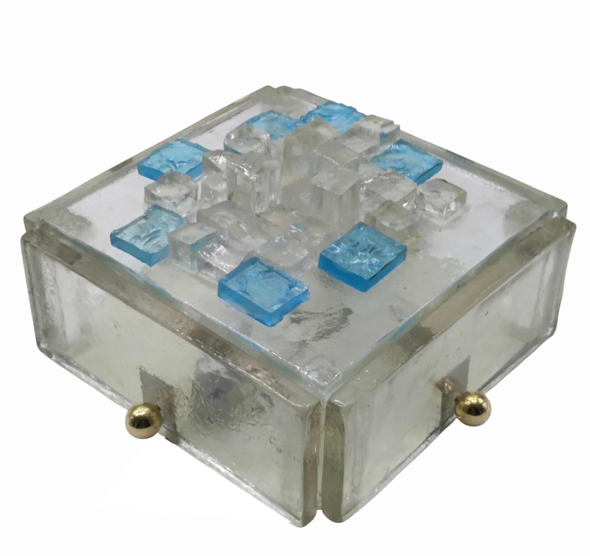 Murano glass wall lamp, produced by Poliarte in the 1970s. 
It consists of a chrome base that supports three layers of glass.
Two layers are colorless glass and a middle layer is blue.
These combined layers create a warm, ambient light.