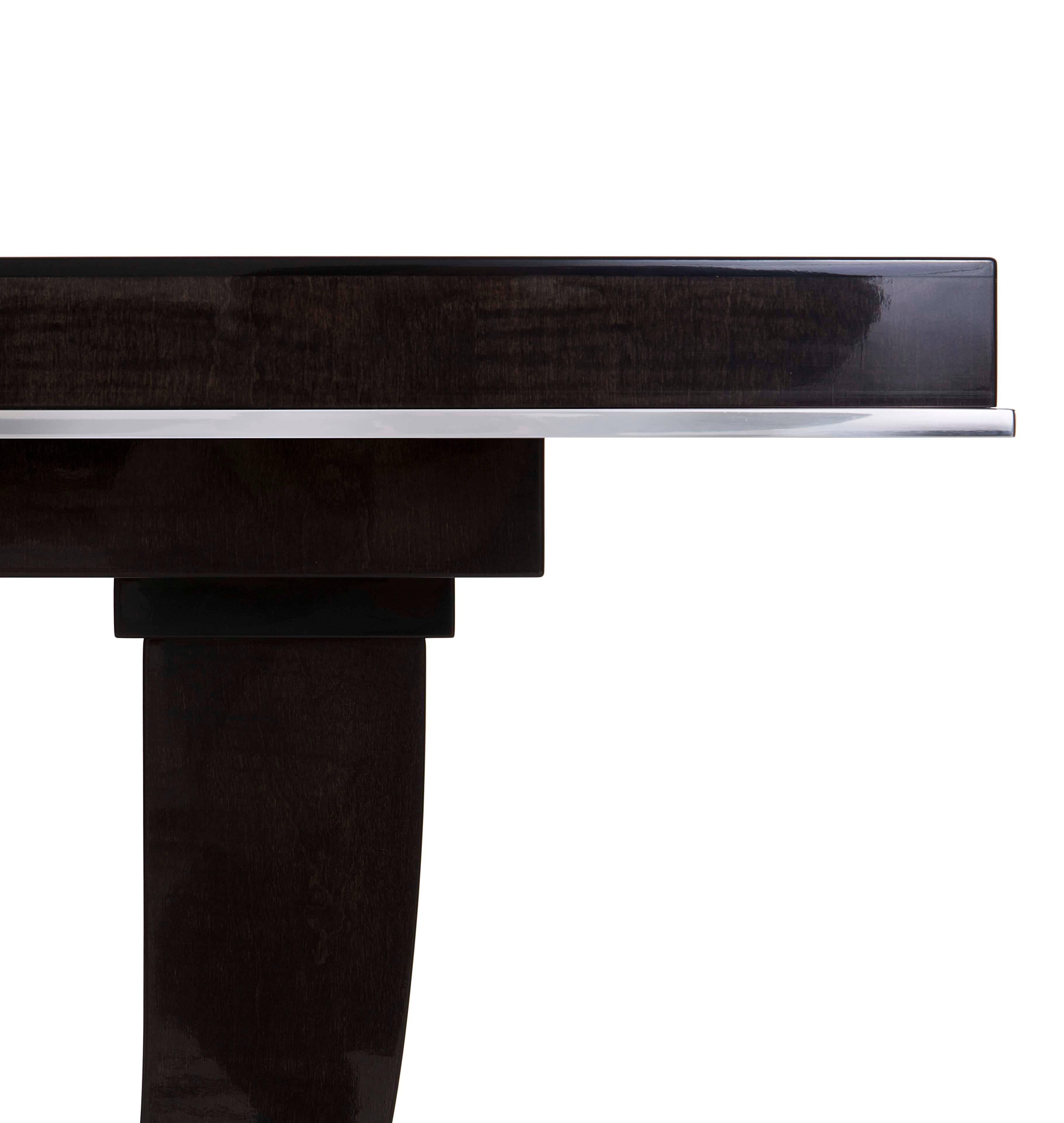 An Art Deco inspired console finished in sycamore black with polished nickel detail.

The Albany console exudes sophisticated Art Deco style with a silhouette directly inspired by the work of iconic furniture designer Emile-Jacques Ruhlmann. The