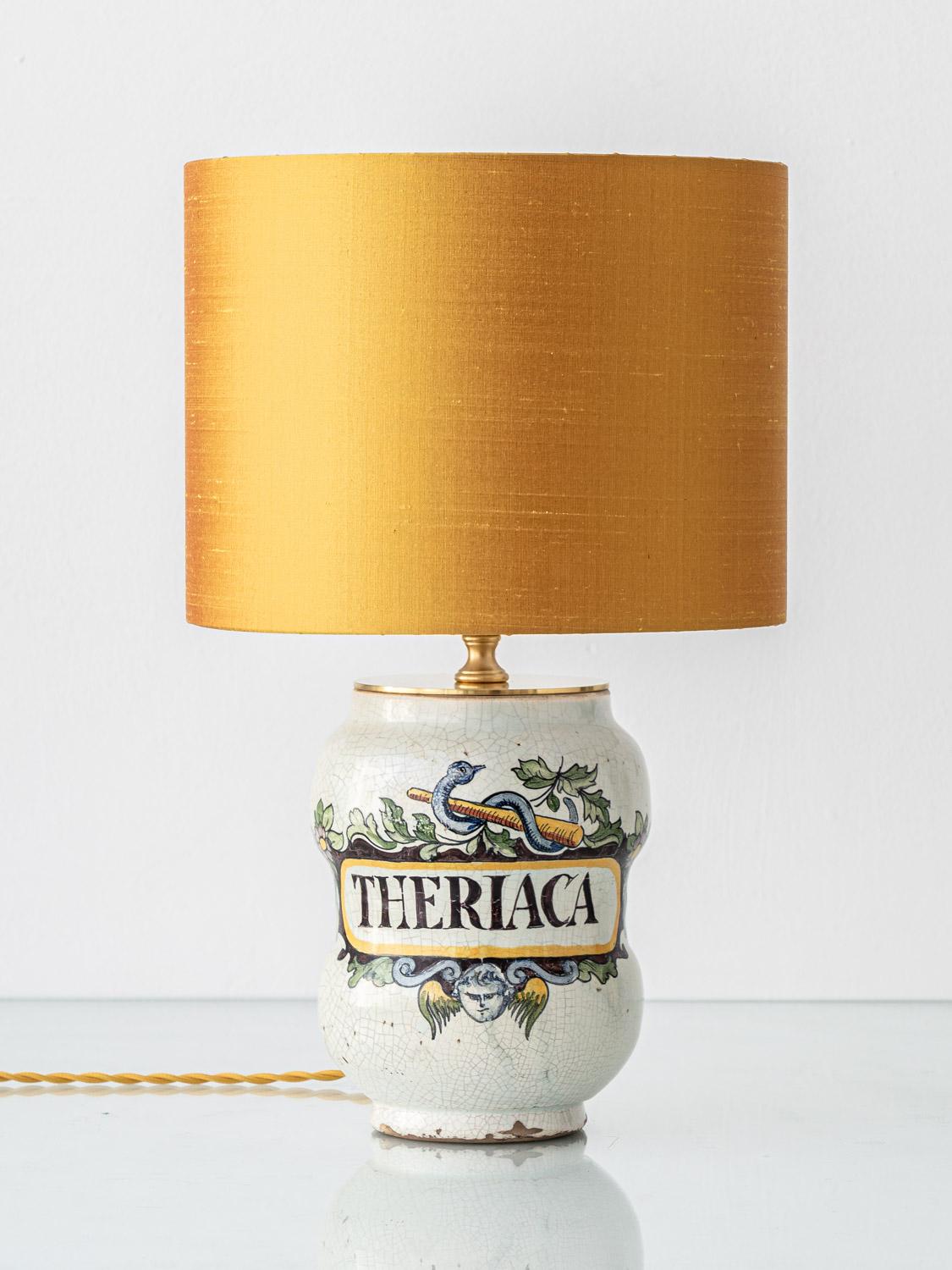 Crafted from a Renaissance revival albarello, Theriaca is a singular table lamp transformed from a 19th-century Italian apothecary jar, likely dating from circa 1870–1885. This antique ceramic vessel takes its name from the ancient medicinal