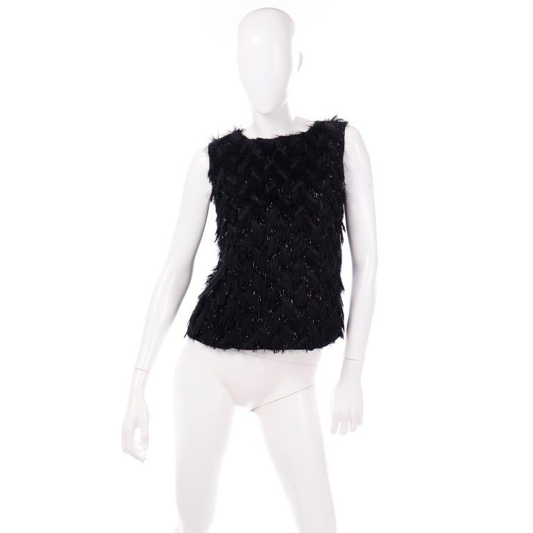 This is a fun and festive black sleeveless evening top designed by Alber Elbaz for Lanvin for their F/W 2014 collection. This particular season was filled with gorgeous fringes from Elbaz. The top has zig zag rows of fabulous fringe across the
