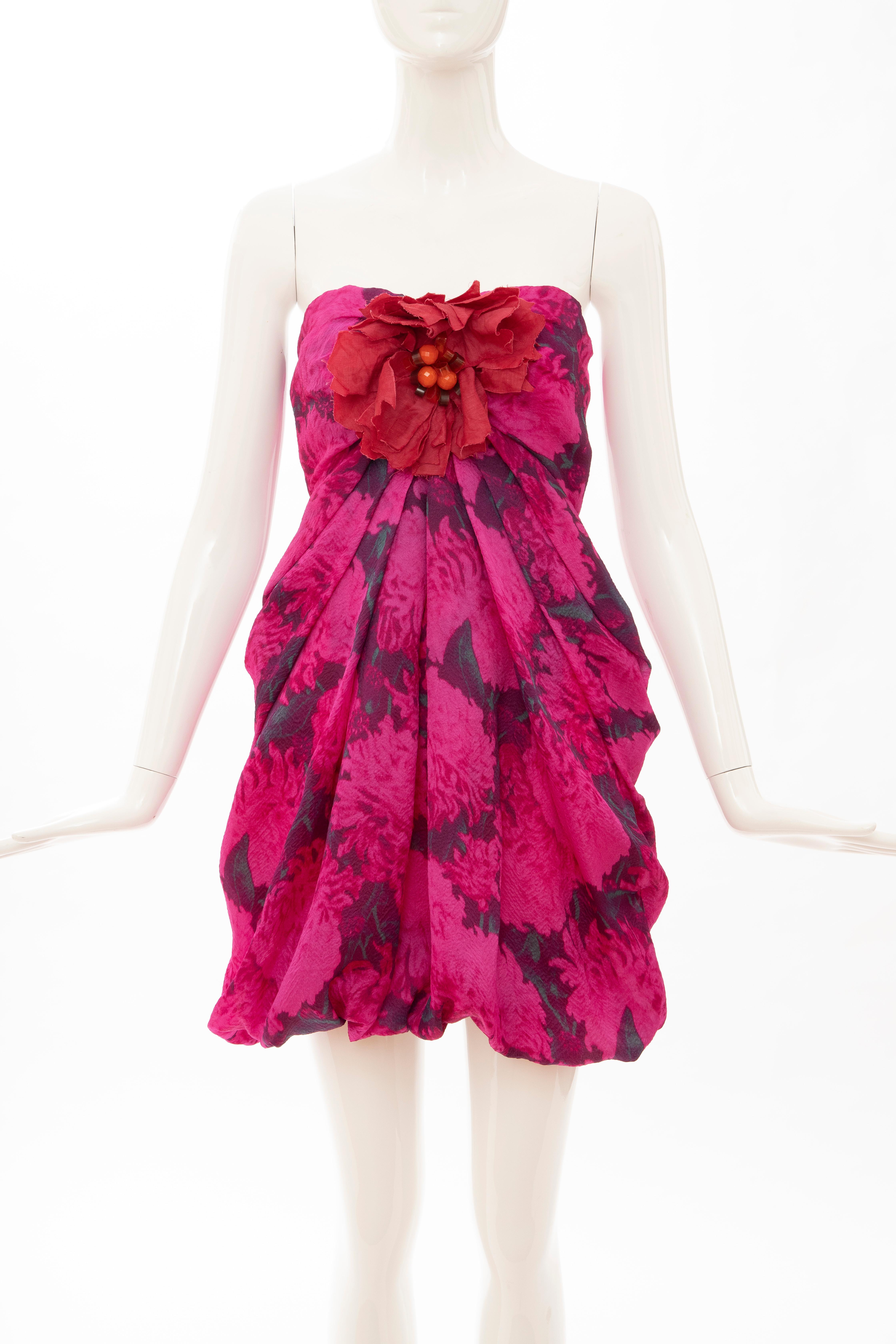   Lanvin, Spring 2010 magenta silk printed floral strapless evening dress with embroidered linen & faceted glass flower at bust with exposed zip and hook-and-eye closure at center back, fully lined in silk.

FR. 36, US. 4

Bust: 25, Waist: 25, Hip: