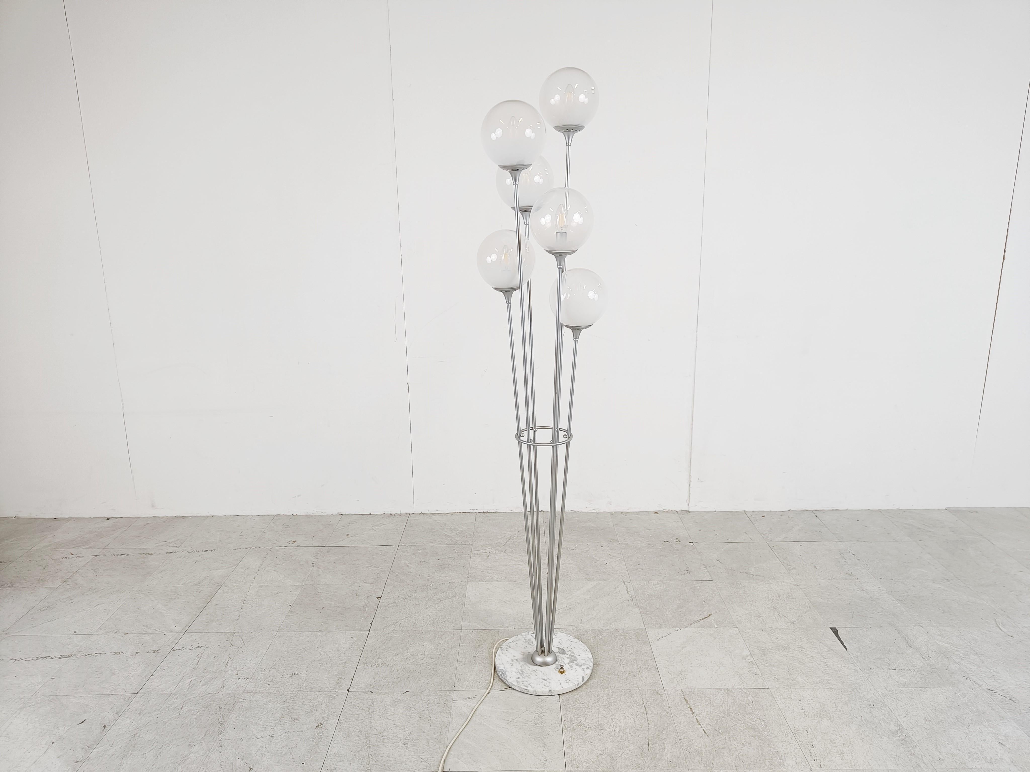 Mid-Century Modern floor lamp model 'Alberello' by Stilnovo italy.

The lamp has a carrara marble base, 6 metal arms each with semi transparent glass globes emitting a nice wam light.

The globes are on different height creating a nice