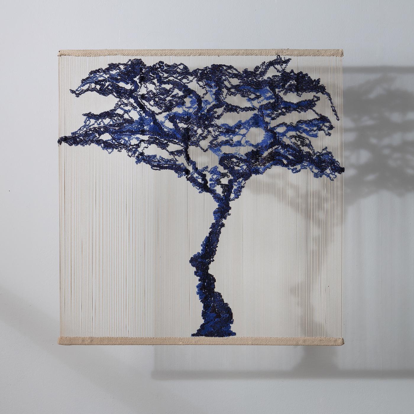 A stunning vertical handwoven tapestry of Japanese inspiration, the Tree is composed of wool, cotton, silk and linen threads in blue using traditional techniques. In a decorative play of shadows, the piece is viewed at its best when hung at a