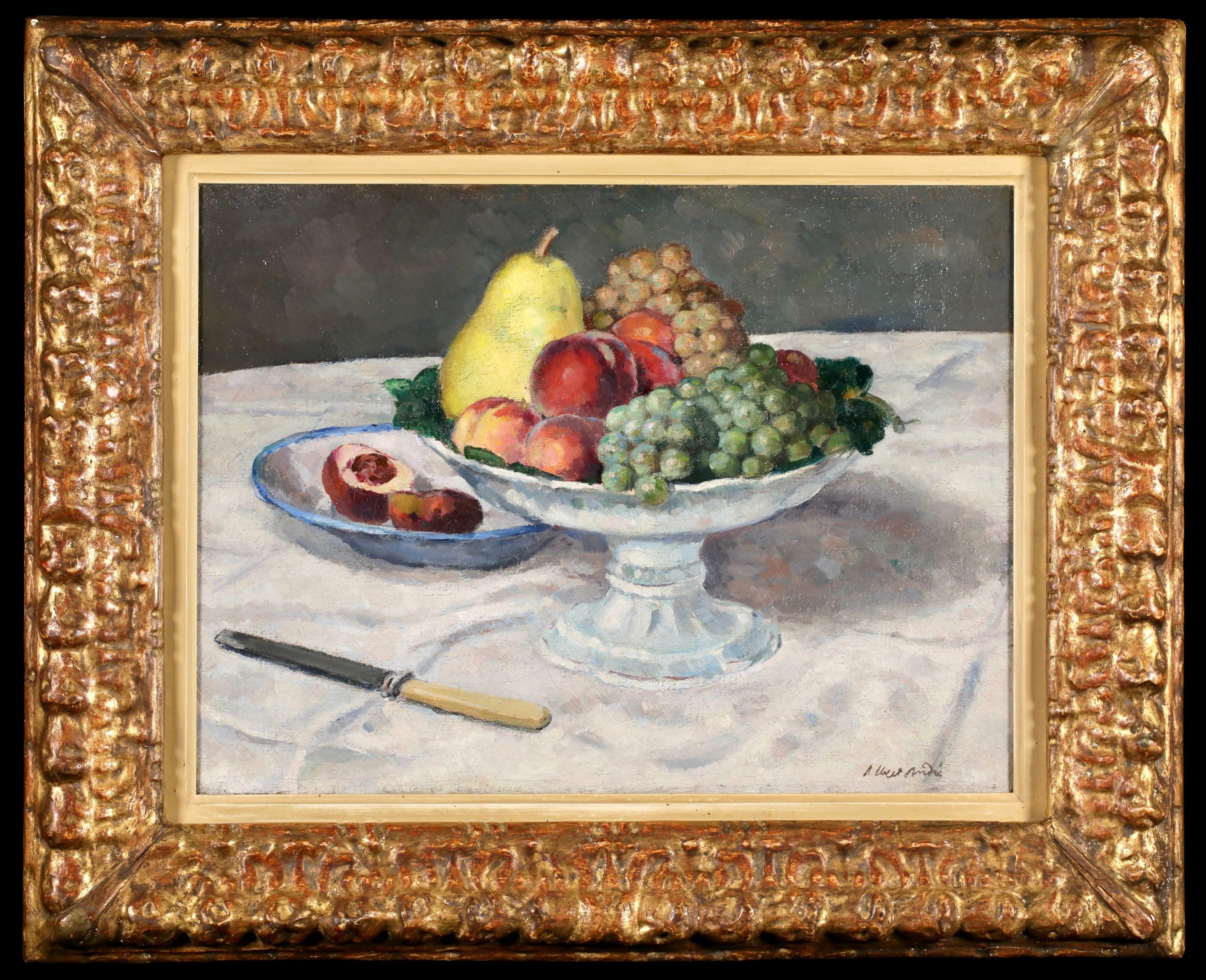 Signed and titled still life oil on canvas circa 1898 by French post impressionist painter Albert André. The work depicts a still life scene in an interior. A glass bowl filled with grapes, peaches and a pear is placed in the centre of the table. To
