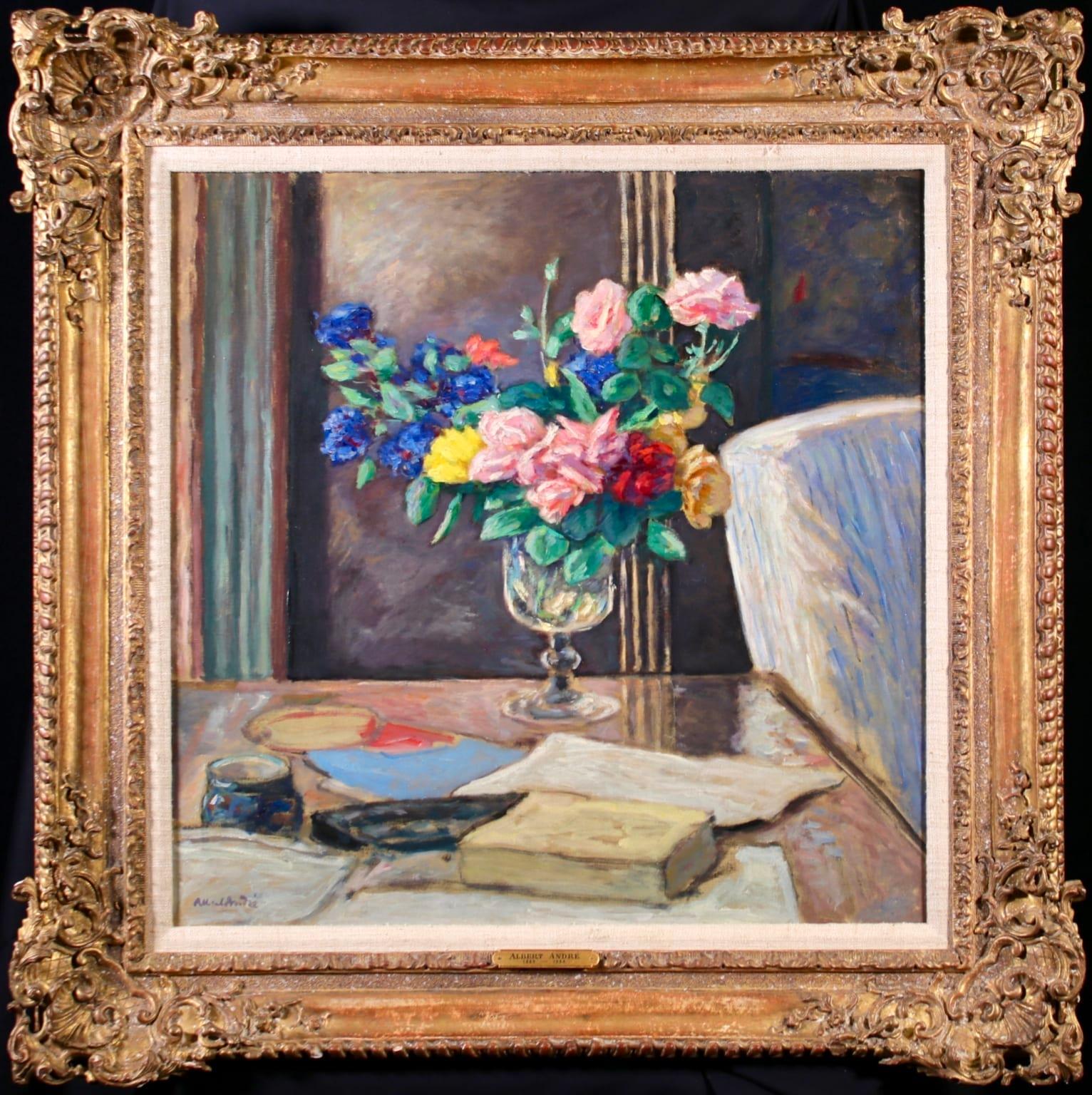 Signed and titled still life oil on canvas circa 1900 by French post impressionist painter Albert André. The work depicts a still life scene in an interior. A vase of pink, yellow, red and blue roses is set upon a table next to books, paperwork and
