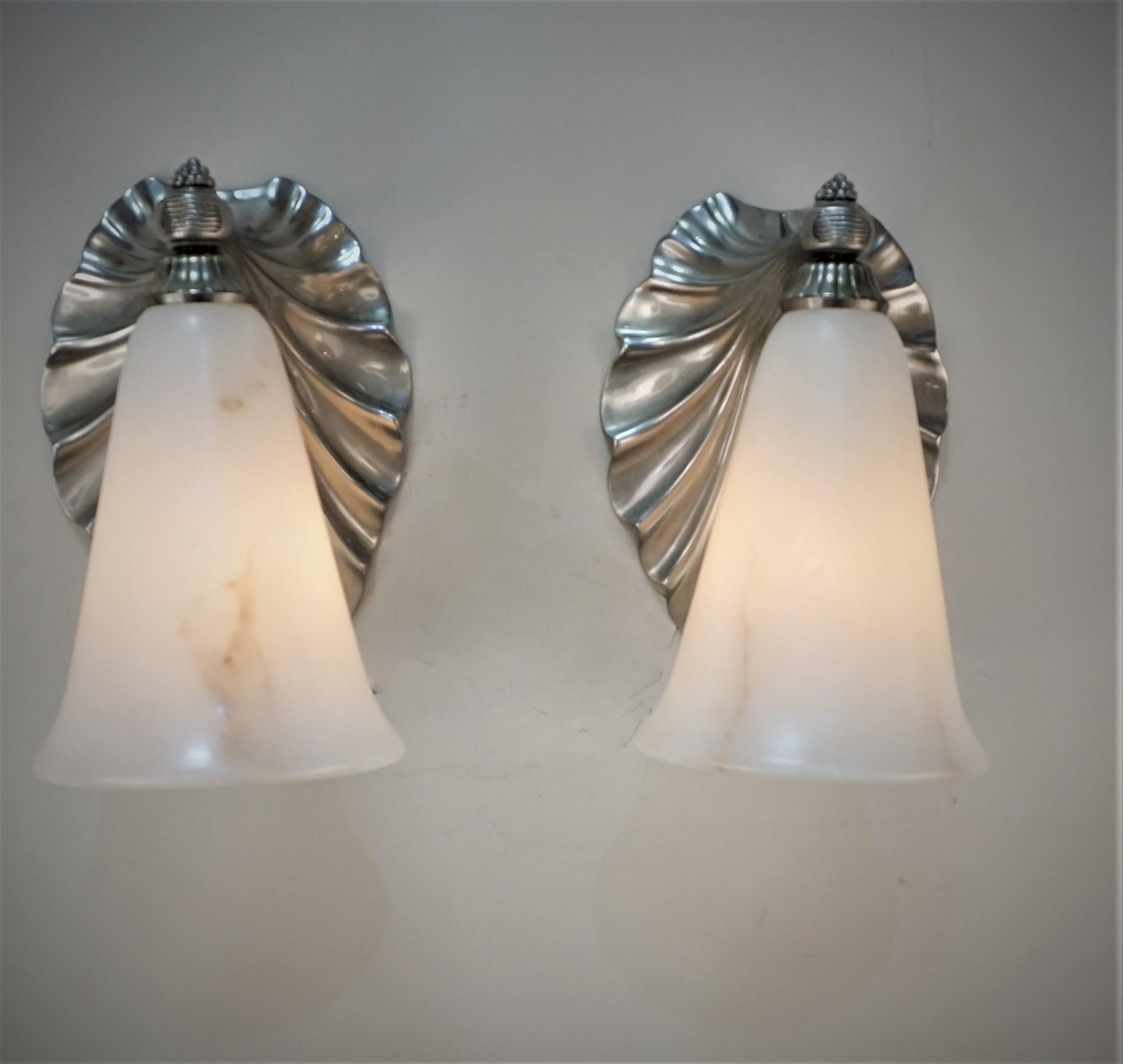 Pair of Art Deco silver on bronze, cone shape alabaster shade wall sconces. 
By Albert Cheuret (French, 1884–1966).