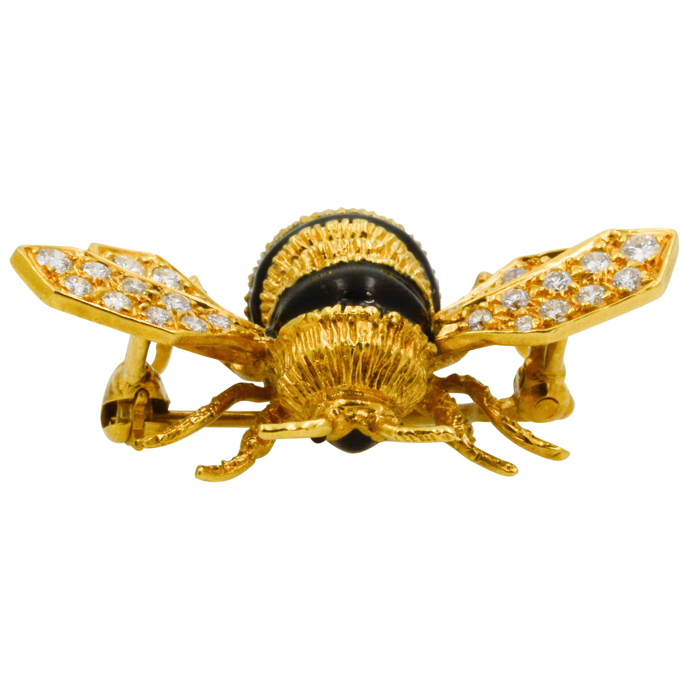 This Albert Lipten 18k yellow gold bee pin features black enamel for its charming stripes and eyes and 28 round diamonds on its wings with a combined total weight of .28 carats GH VS. 