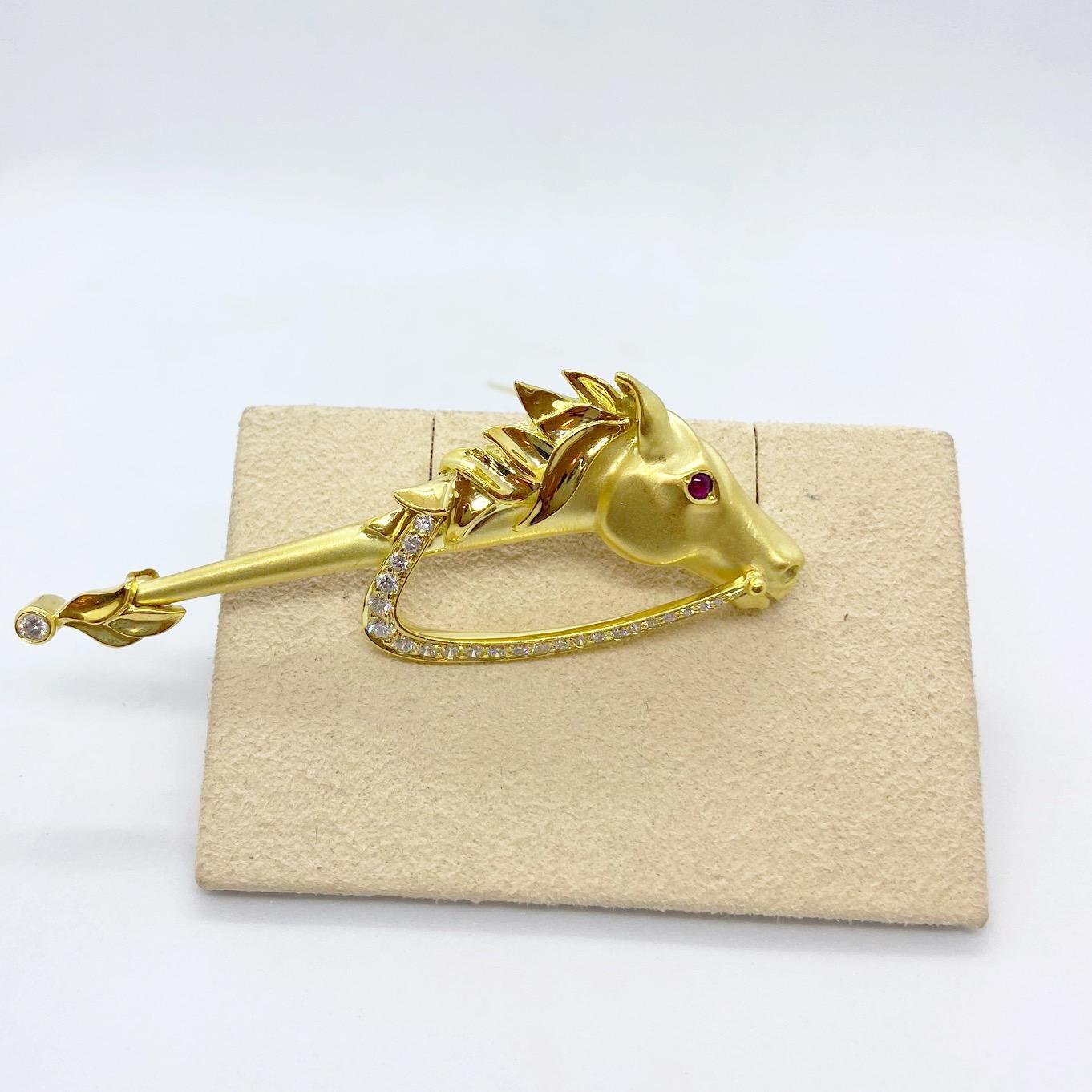 Reminiscent of a hobby horse, this 18 karat yellow gold brooch will be forever a classic.
It is designed in a satin finish with a contrasting hi polish for the horse's mane. The rein is set with round brilliant diamonds along with a single bezel set