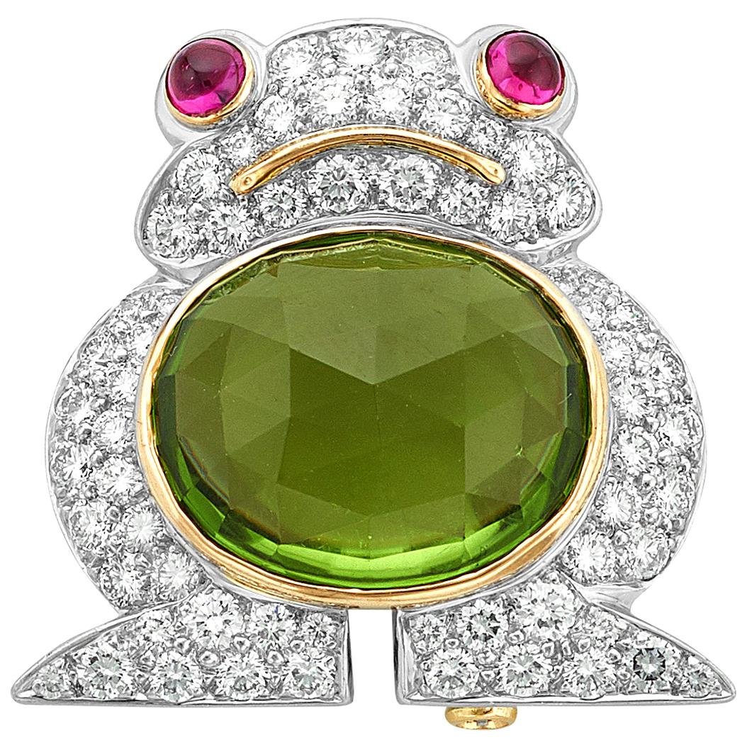 Designer Albert Lipten created this charming platinum and 18 karat white gold frog brooch set with a 4.30 carat oval Peridot and surrounded with 62 round brilliant cut diamonds (2.50 carats total weight) and two (2) ruby cabochons eyes (0.40