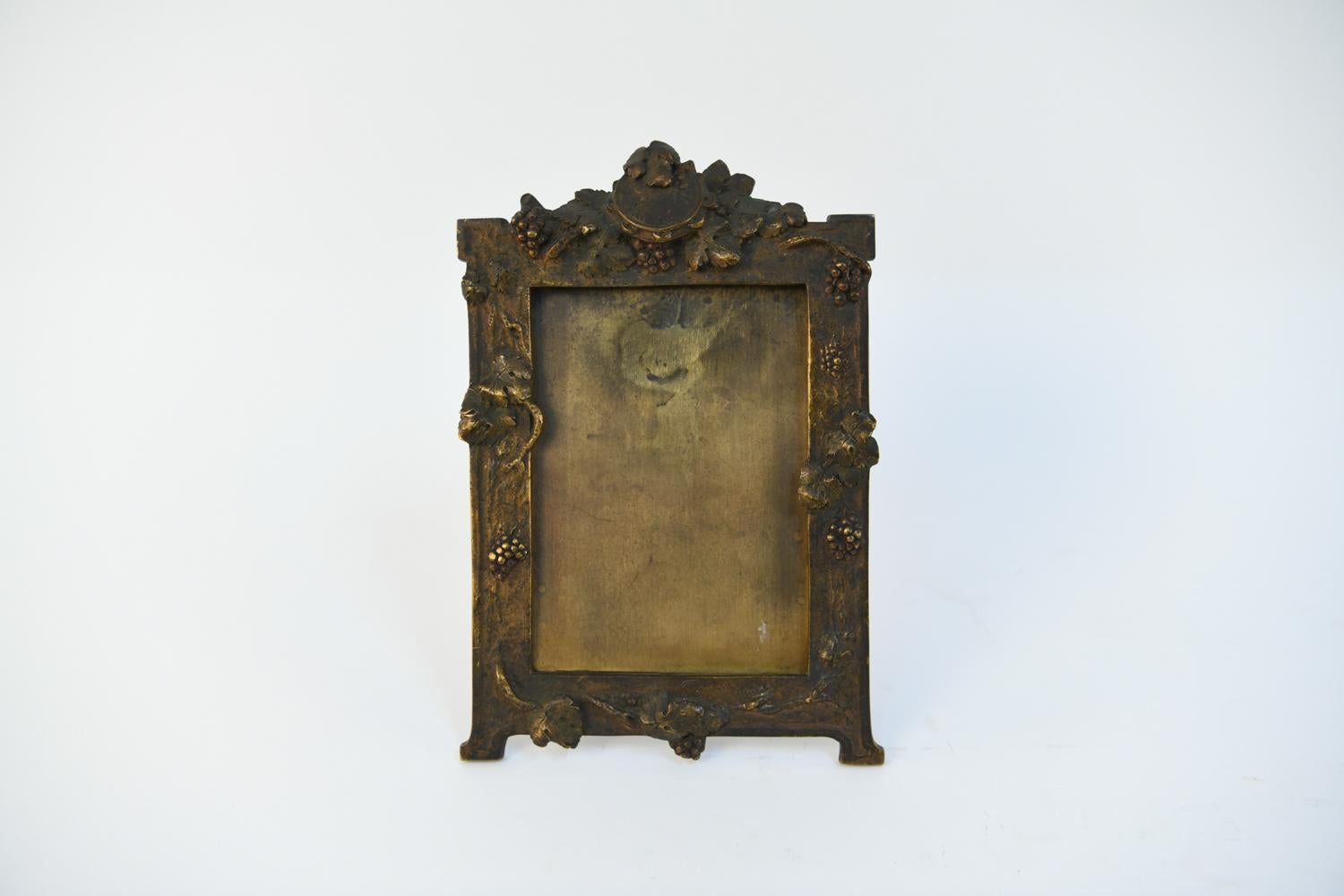 A fine, Art Nouveau cast bronze standing frame with grape fruit and foliage with central crest at top. The original patina will bring you back to the turn of the century. Signed, A. Marionenet (French, 1852-1910), will fit an H 6.25