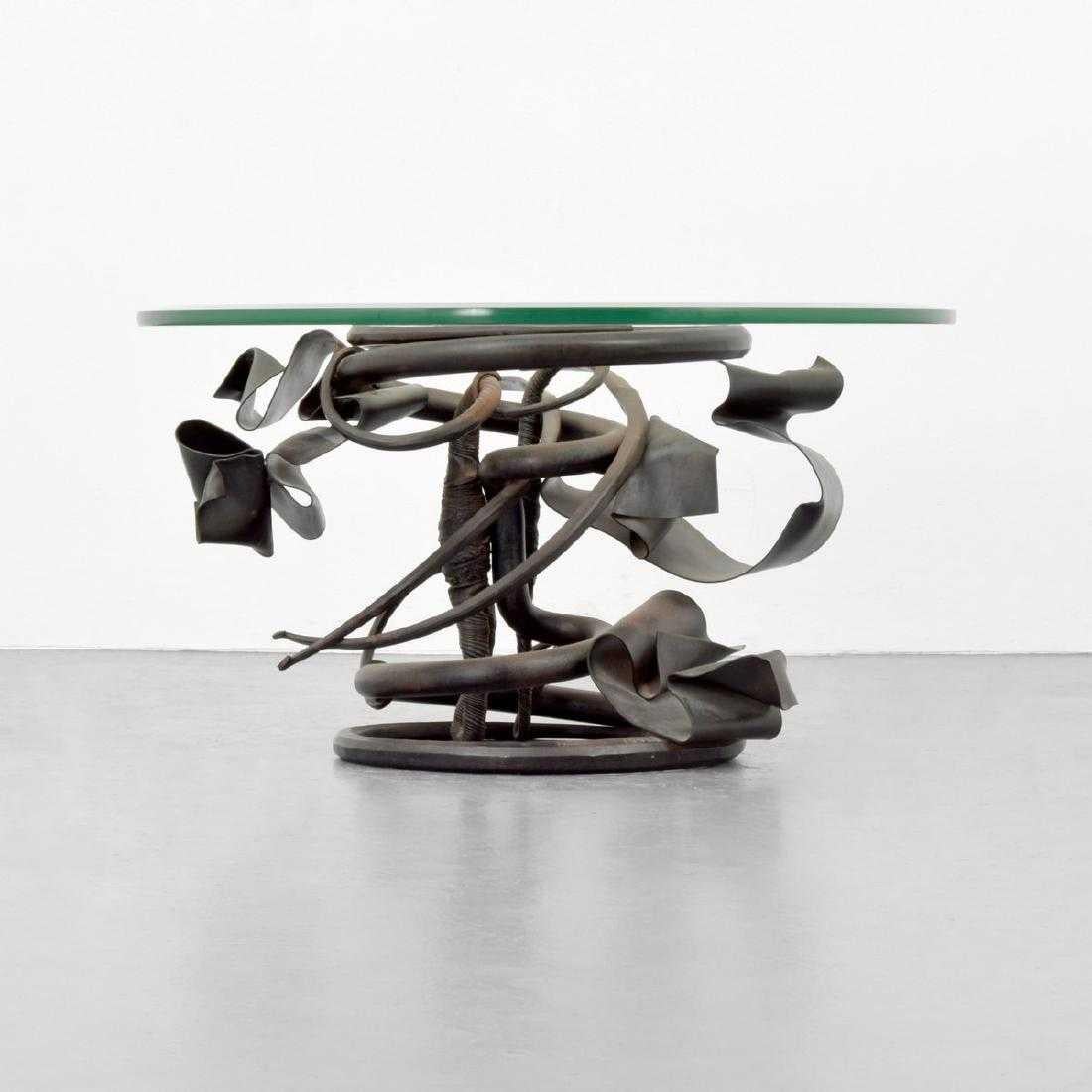 Coffee table by Albert Paley (b. 1944). Table is from an edition of fifteen. Provenance: Collection of Donna Schneier, Manalapan, Florida.

Markings: Signed; 1991

Materials: Forged steel, glass.
 