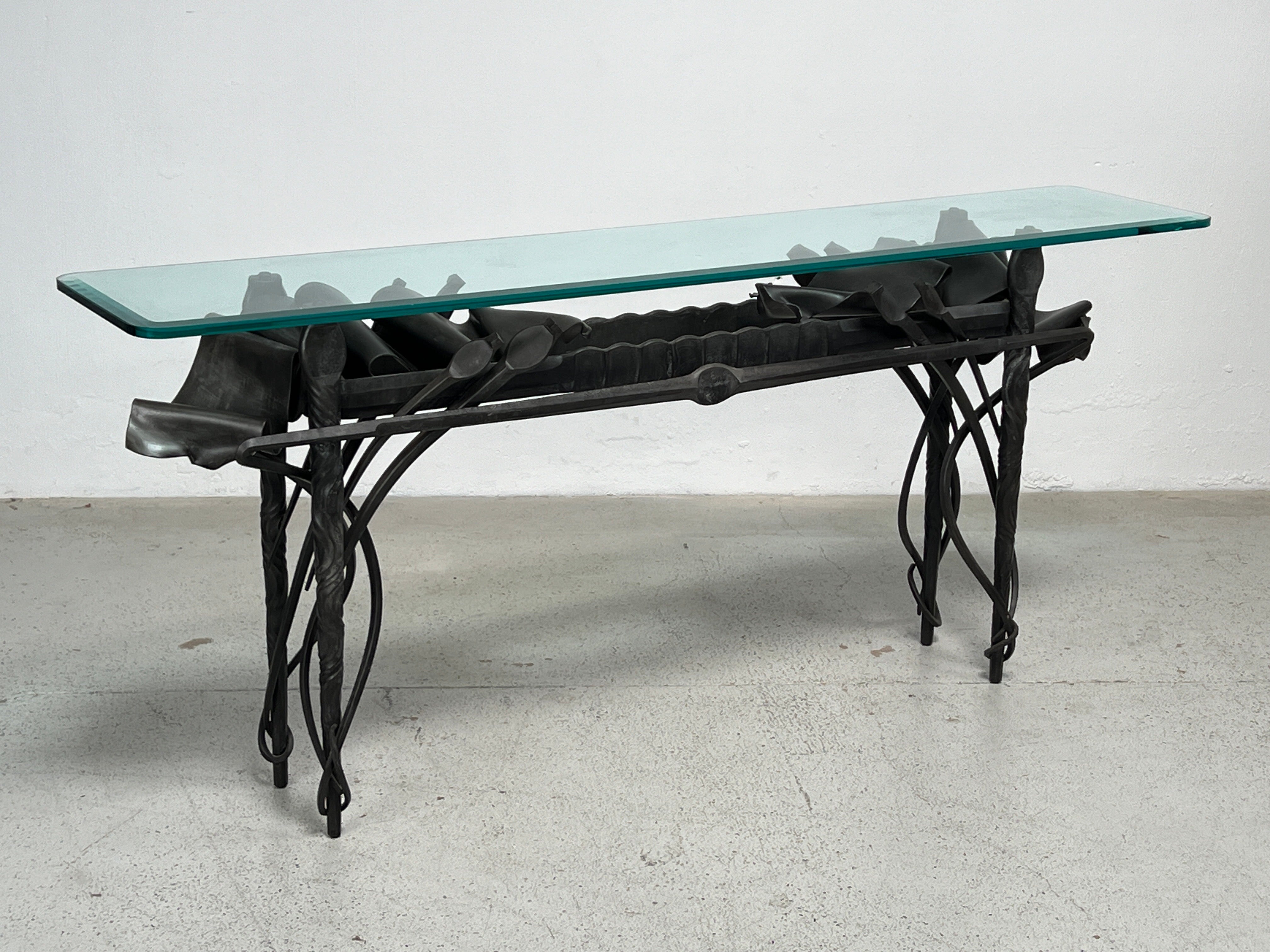 A patinated steel console table with glass top made by Albert Paley signed and dated 1989. 

Published: Edward Lucie-Smith, The Art of Albert Paley, New York, 1996, pp. 149, 205