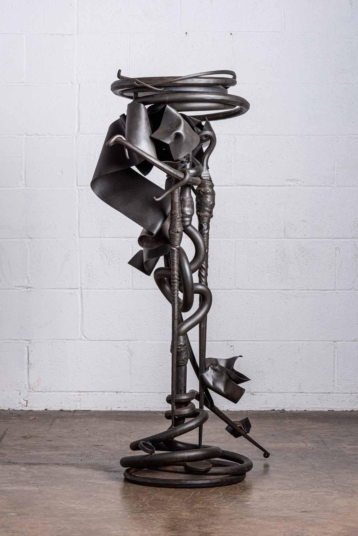 A forged steel plant stand with slate top. Signed and dated Albert Paley, 1993.