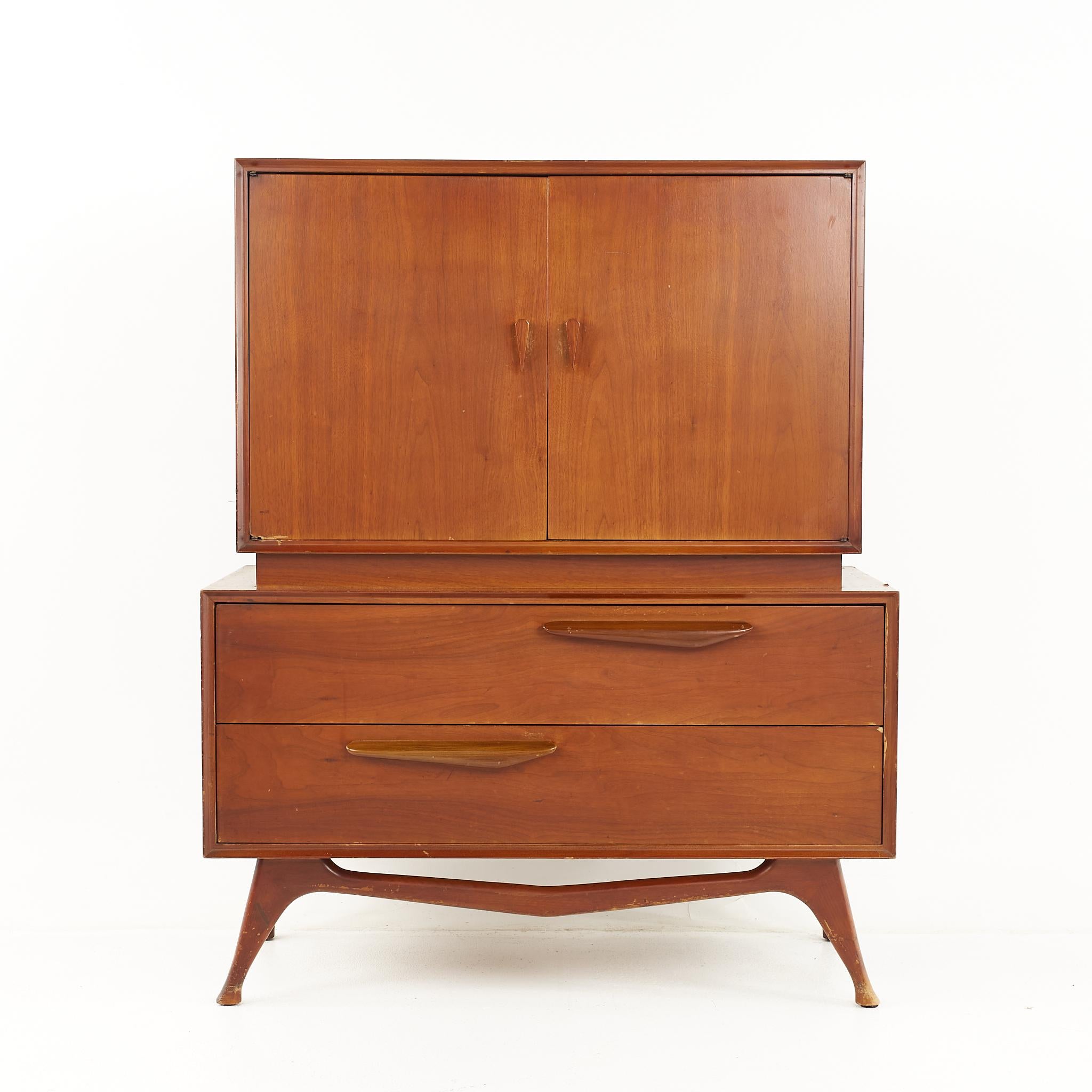 Albert Parvin style mid century walnut gentlemans highboy dresser

The dresser measures: 40 wide x 19 deep x 50 inches high 

All pieces of furniture can be had in what we call restored vintage condition. That means the piece is restored upon