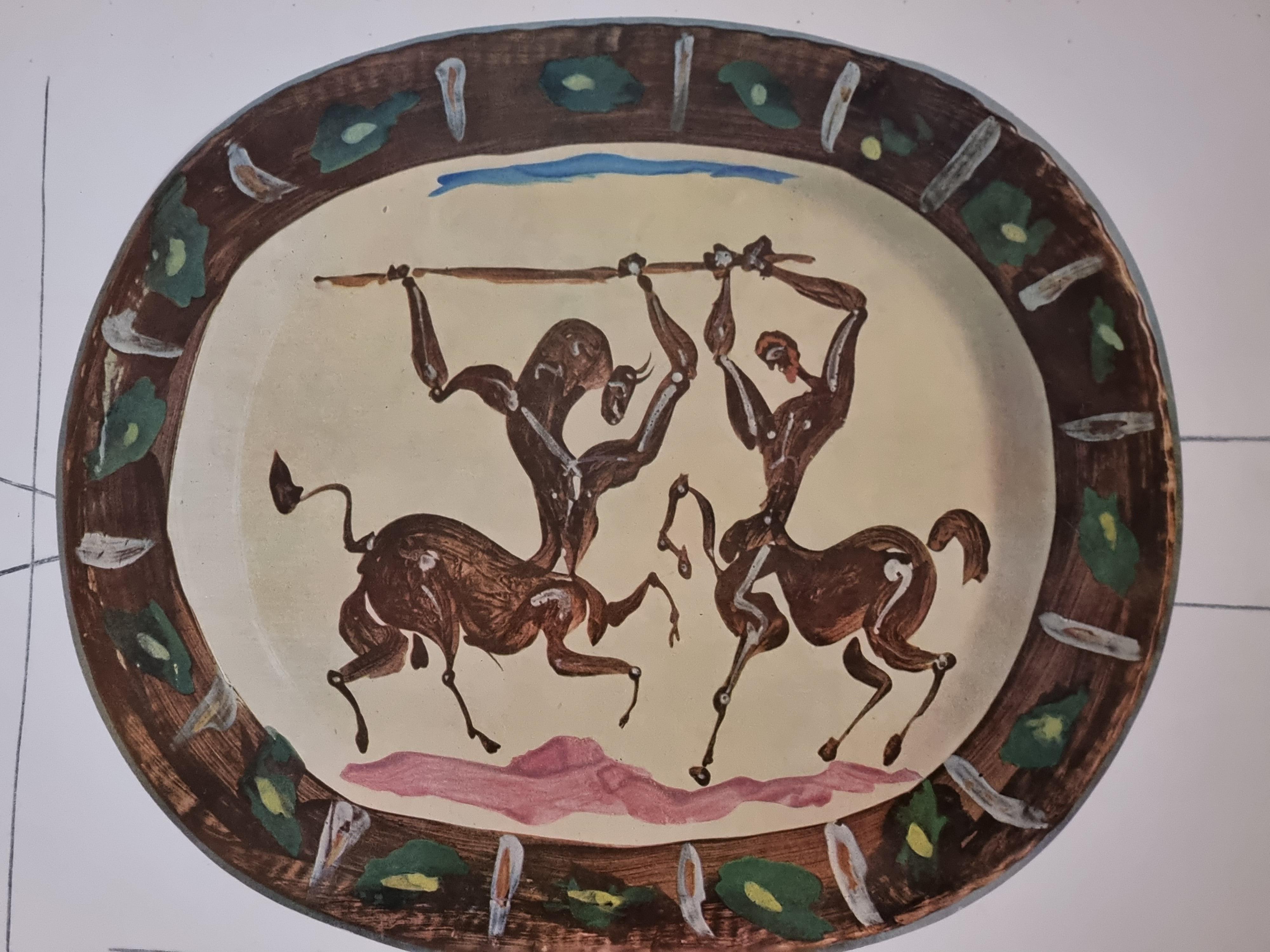 An exquisite shiny polychrome print of Picasso Vallauris ceramic plate depicting battle of Centaurs. The color print is attached to a thick, high quality paper with decorative lines. 

The print is originally from a Limited Edition Art Folio