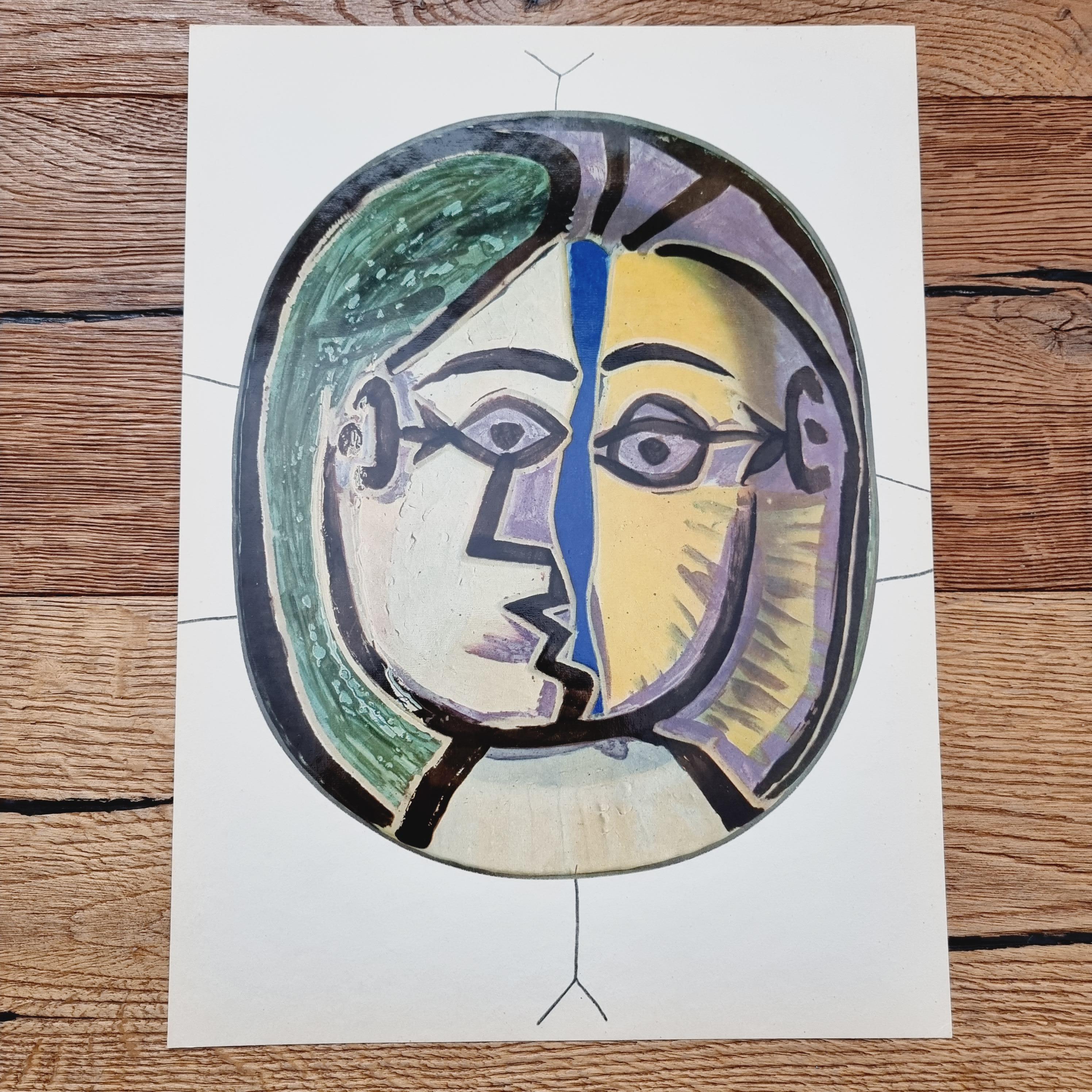 An exquisite shiny polychrome print of Picasso Vallauris ceramic plate depicting a face. The color print is attached to a thick, high quality paper with decorative lines. 

The print is originally from a Limited Edition Art Folio 