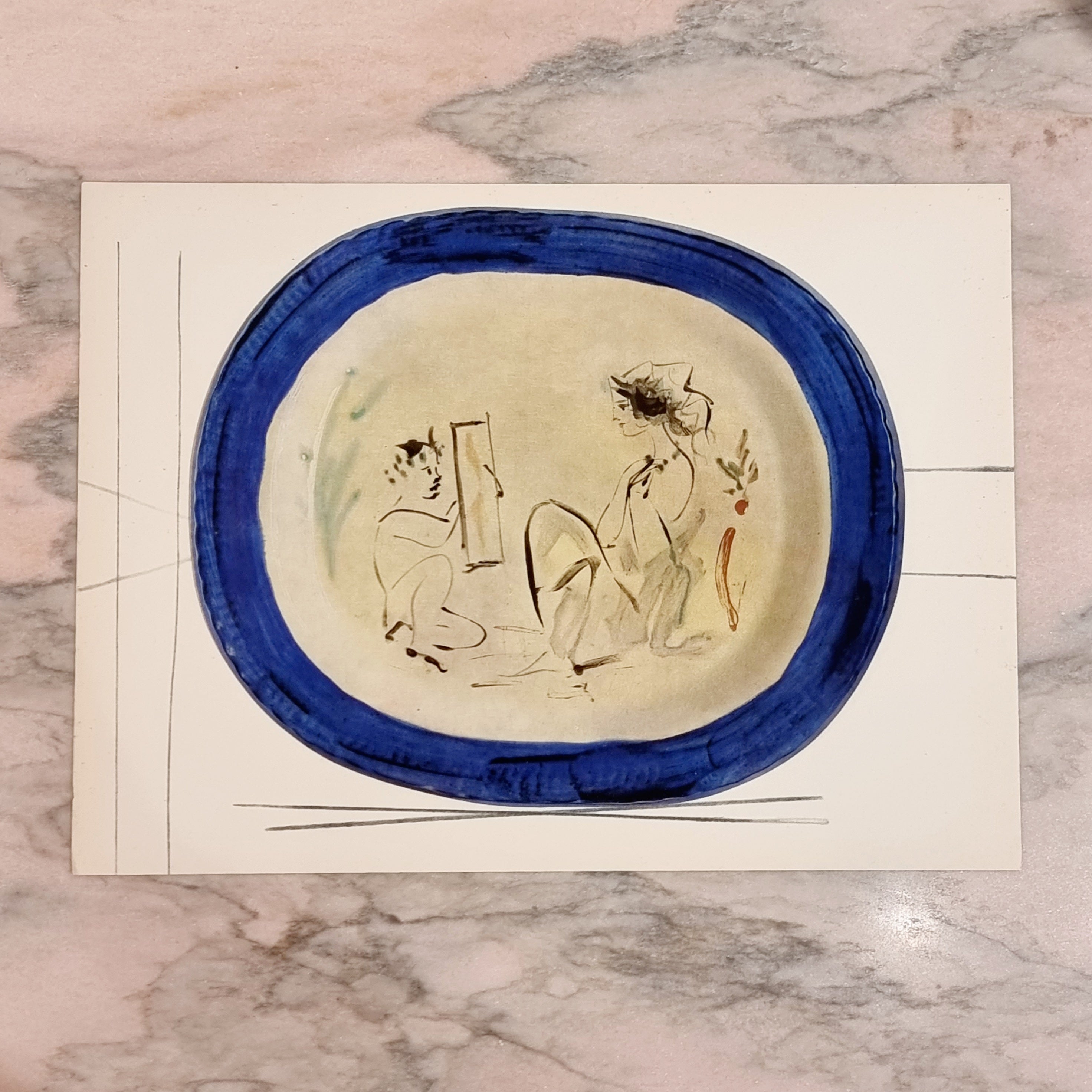 An exquisite shiny polychrome print of Picasso Vallauris ceramic plate depicting a painter with muse. The color print is attached to a thick, high quality paper with decorative lines. 

The print is originally from a Limited Edition Art Folio