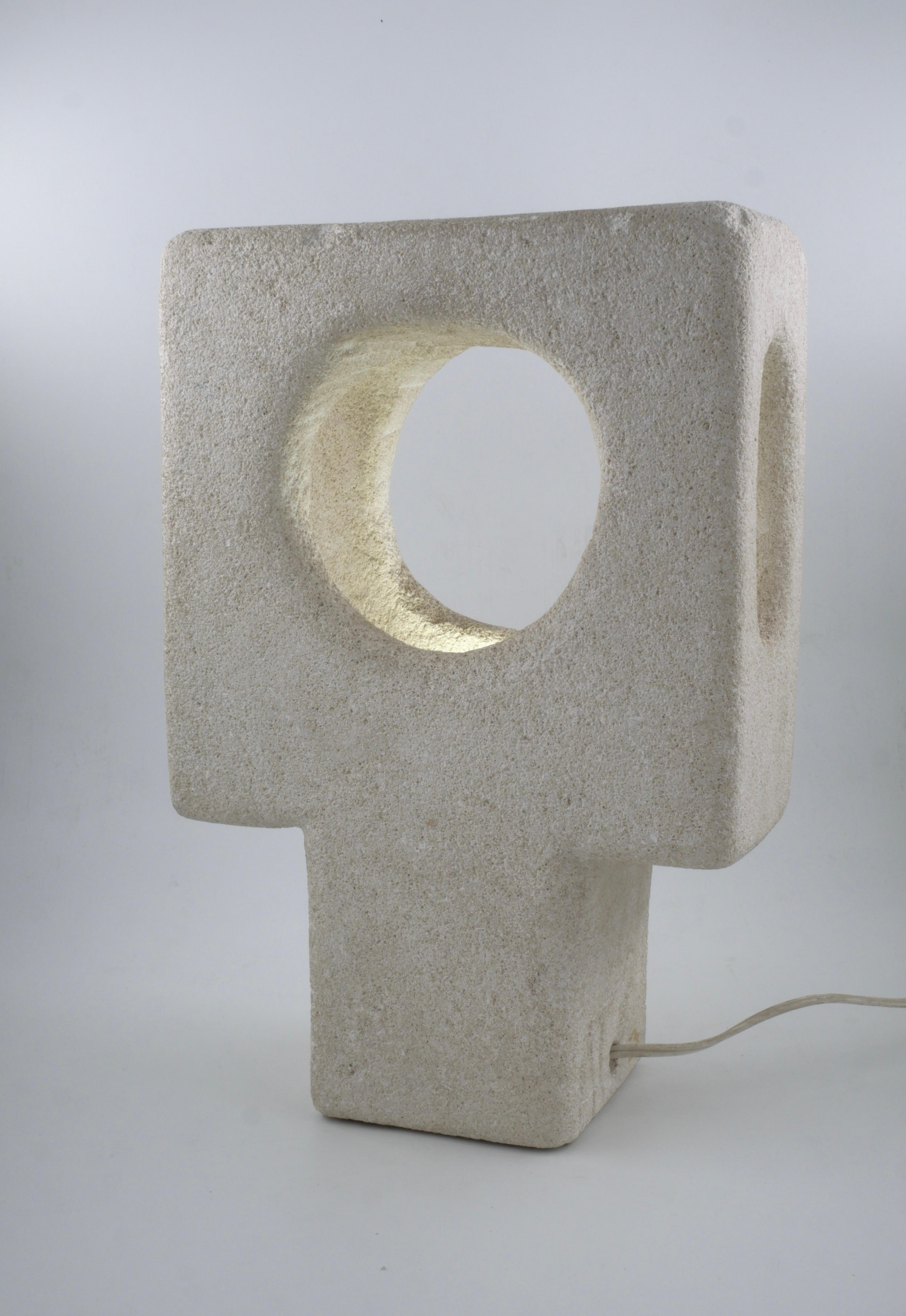 Sculpture lamp made by Albert Tormos in the early 70's. The lamp is carved in the Luberon stone that was found near Saint Tropez where the workshop of Albert Tormos was located.
This sculpture benefits from a double sign of authentication: AT