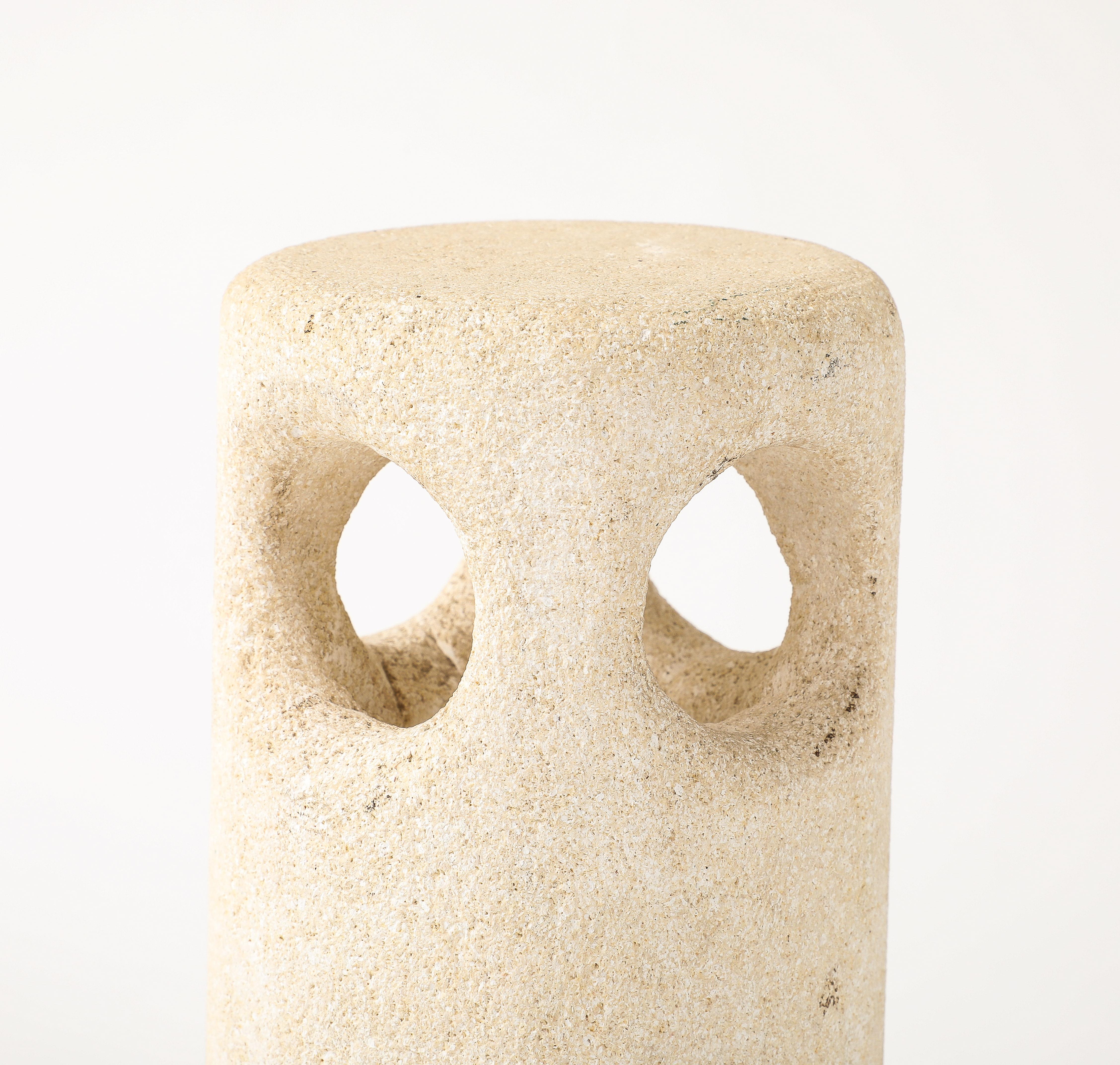 Cylindrical lamp carved out of Pierre du Gard stone with 4 holes around the top to let the light pass through.