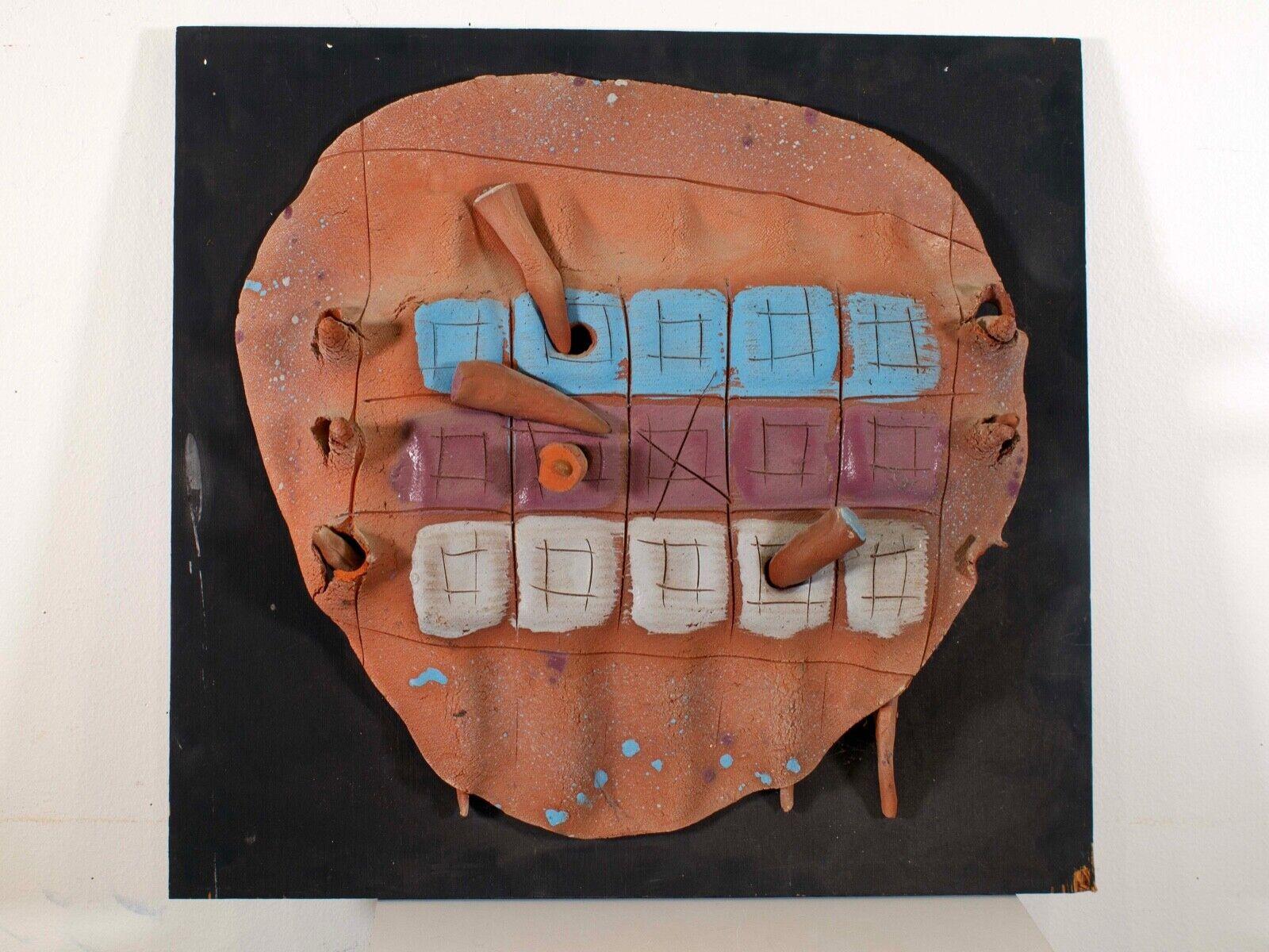 An eclectic modernist contemporary ceramic studio art sculpture on board titled “Kathy’s Game” by Detroit artist Albert Young. Terracotta ceramic piece with hand painted details in blue, purple, and white. There is a tribal or native-like quality to