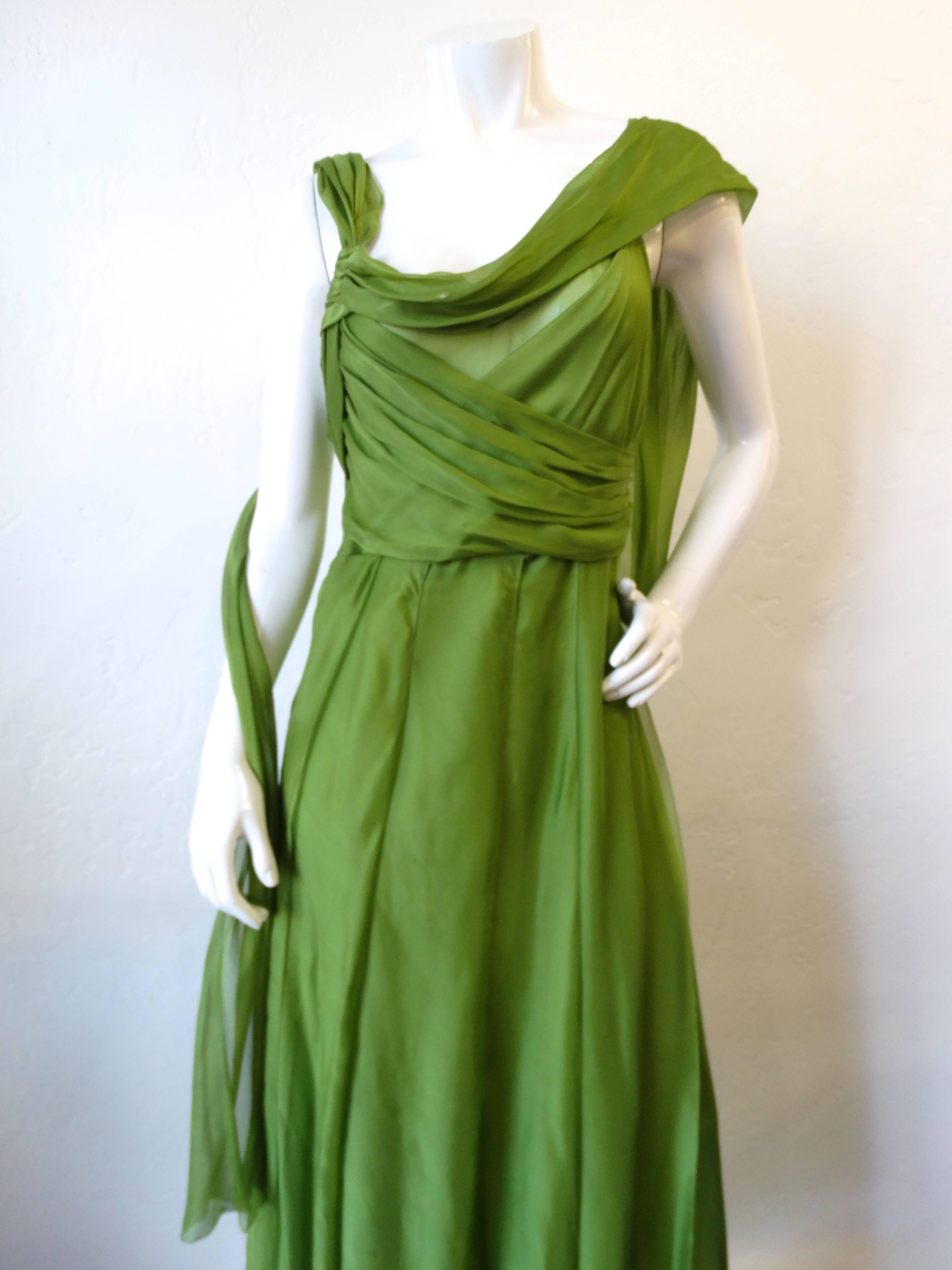 The most incredible goddess dress from Alberta Ferreti! Made of a silk chiffon fabric in a lively green color, draped to flatter the natural figure. Layered, almost carwash style skirt with slits up to the knee throughout. Sash suspended from either
