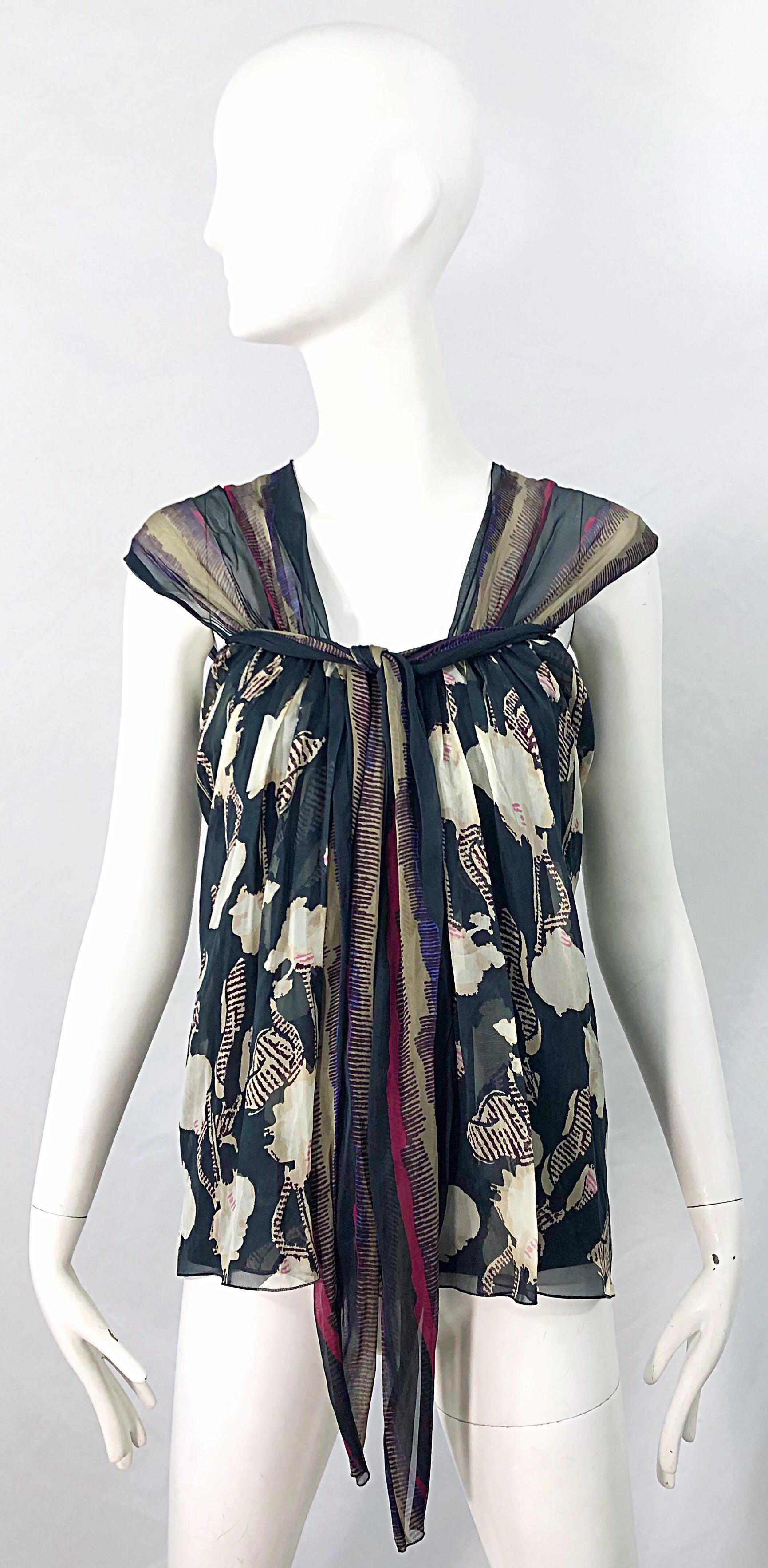 Beautiful vintage late 90s ALBERTA FERRETTI printed silk chiffon cap sleeve blouse / top ! Features grey, pink, purple, ivory and beige throughout. Hidden zipper up the back with hook-and-eye closure. Can easily be dressed up or down. Great with