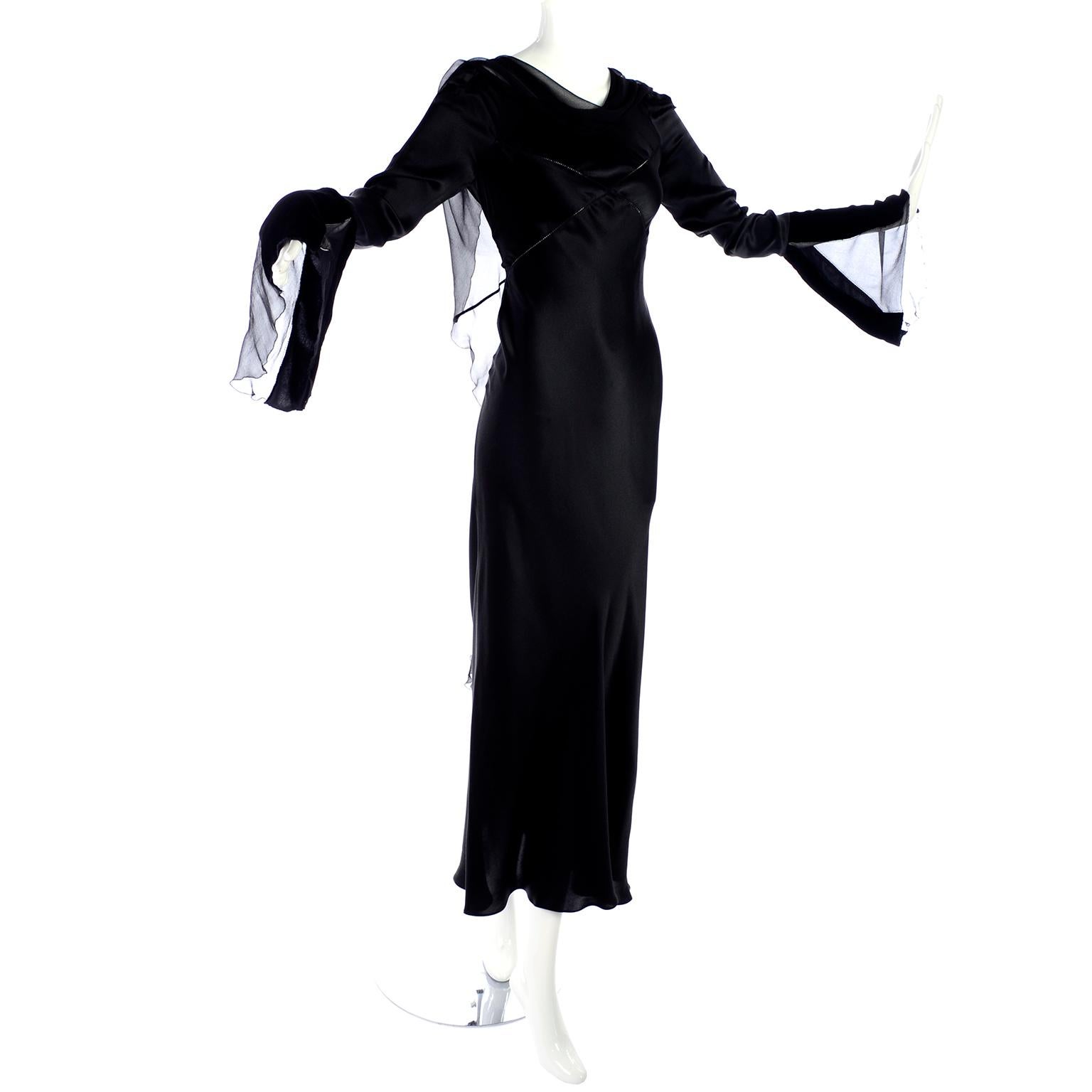 This is a vintage late 1990's black silk Alberta Ferretti evening gown with many of Ferretti's signature fine elements. Ethereal movement defined a lot of Alberta Ferretti's dresses in the 1990's and this dress is a perfect example of that. There is