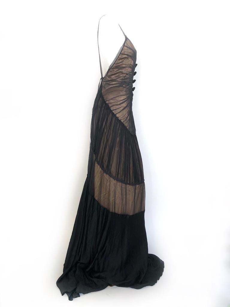 This gown is sexy with out being vulgar, the gathered sheer black overlay over nude fabric is the perfect illusion, the open back shows off the body without showing too much.