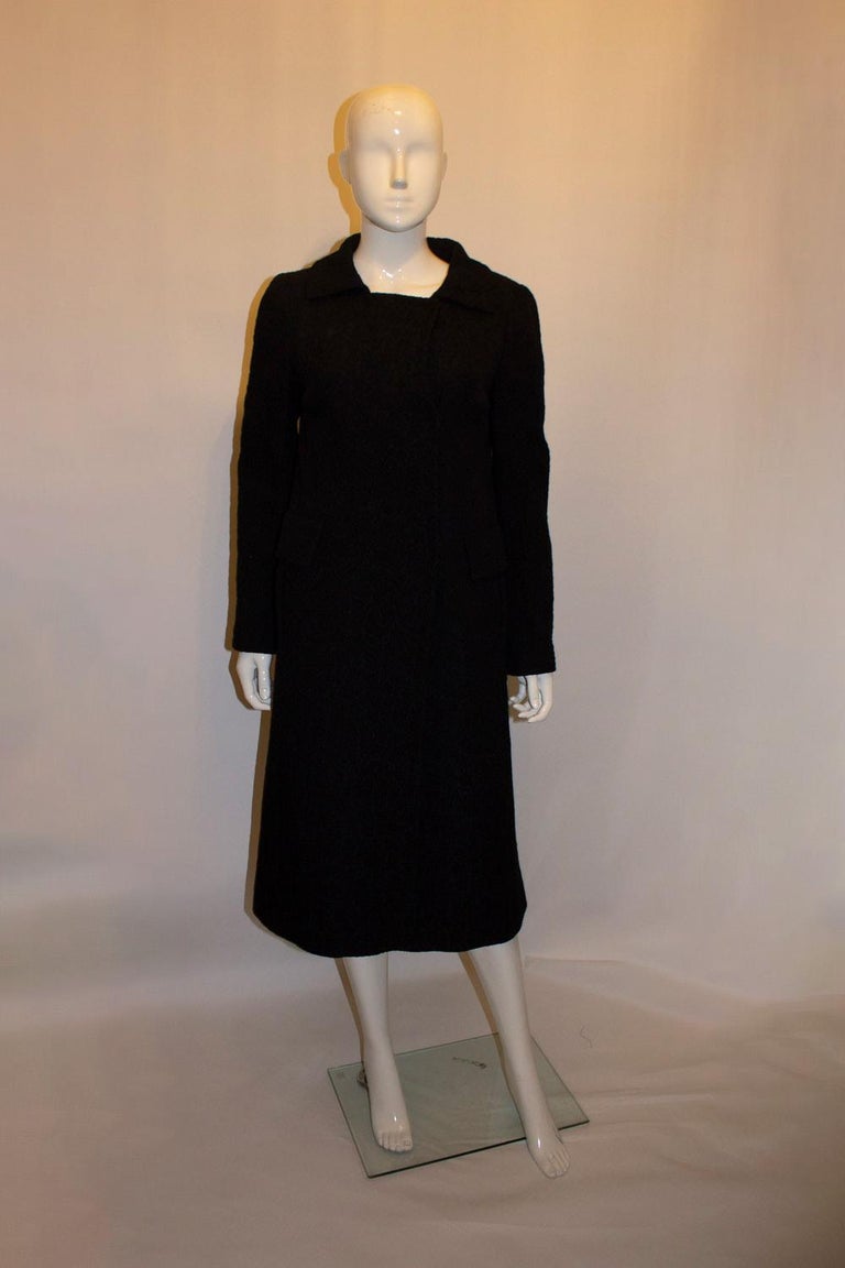 A chic and easy to wear black silk coat by Alberta Ferretti. The coat is 100 % silk , lined and has two faux pockets. UK size 12. Bust upto 39'', length 44''