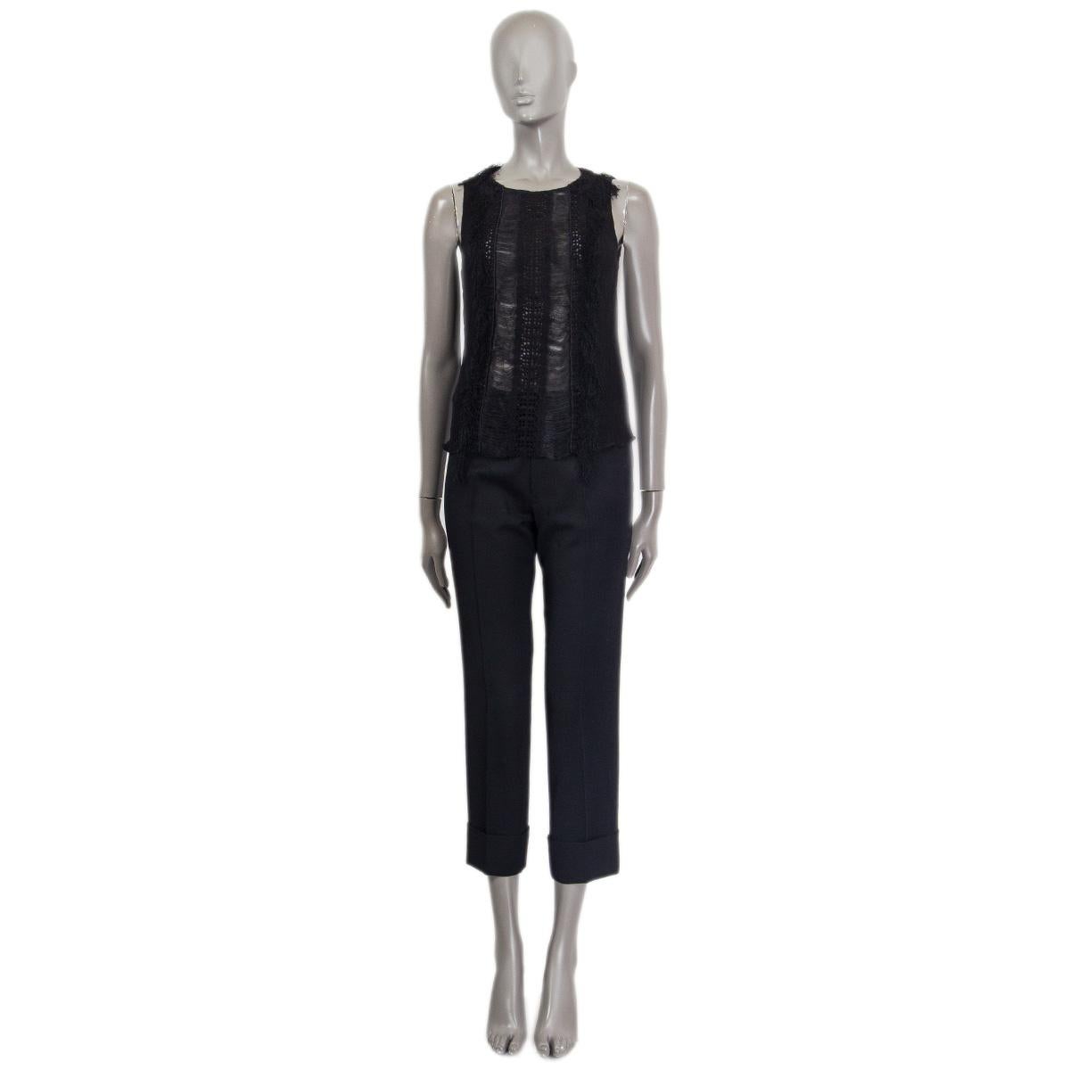 100% authentic Alberta Ferretti sleevless sheer fringed top in black silk (100%), rayon (45%), cotton (43%) and polyester (12%) with crochet detail in the middle. Keyhole and button closure on the back. Has been worn and is in excellent condition.