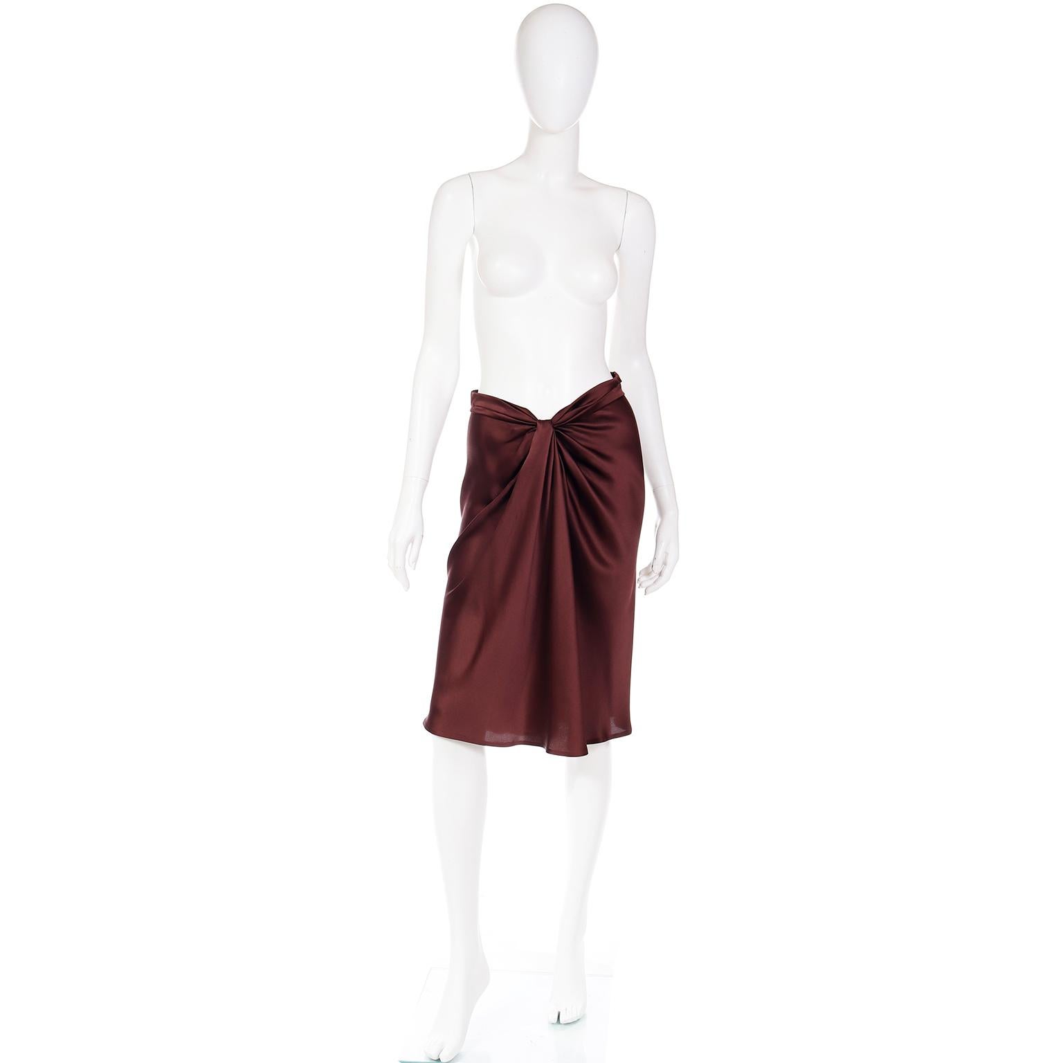 This early 2000's Alberta Ferretti chocolate brown skirt is in an ultra luxurious silk charmeuse. This skirt has a gathered v shape waist with lovely draping at the center, and a hidden center back zipper for closure. These skirts are so current