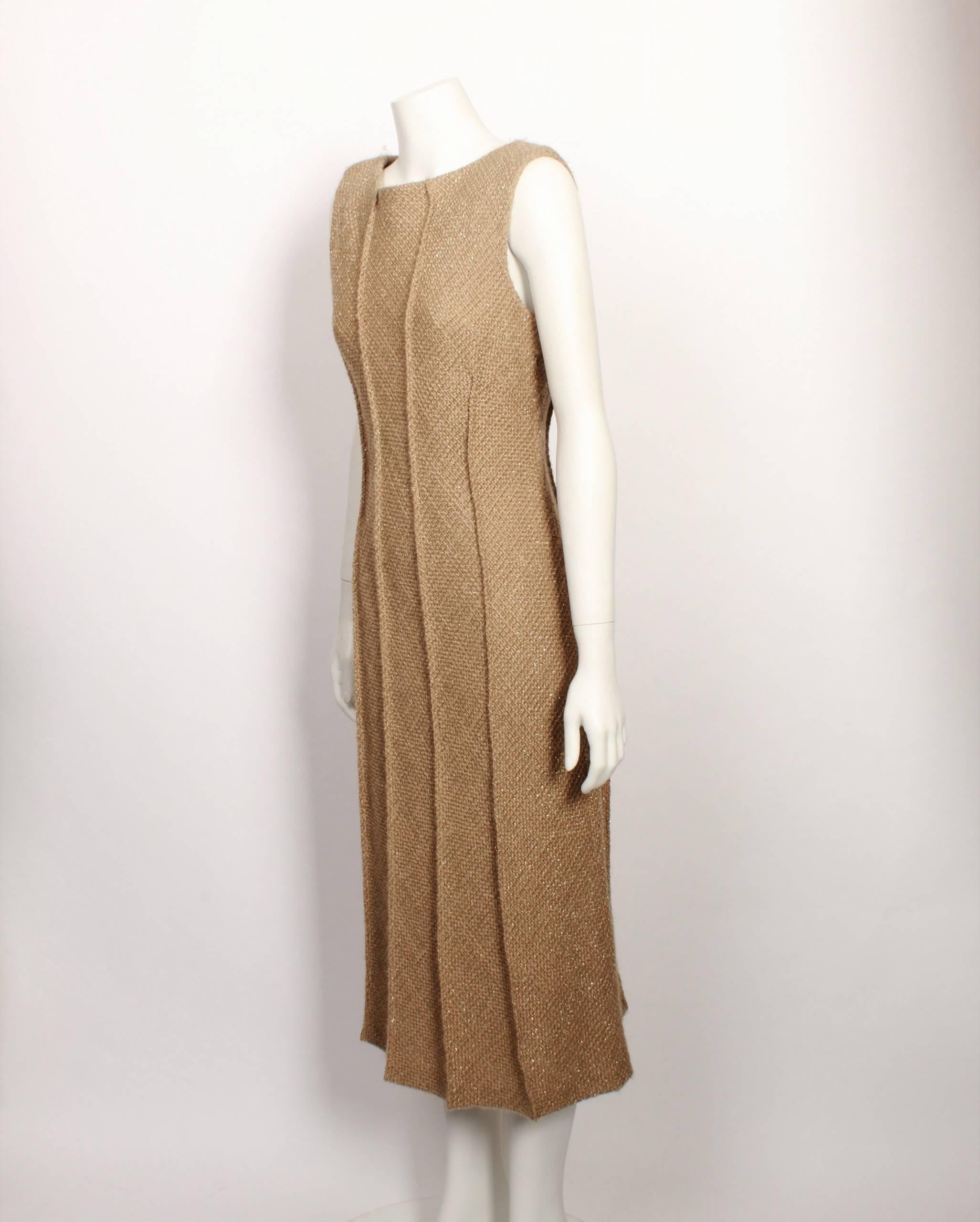 Italian women's wear designer Alberta Ferretti is known for her feminine, subtle designs. She employs technique such as beading and embellishments. 

This sleeveless metallic beige cocktail dress has an invisible zipper down the left hand side under