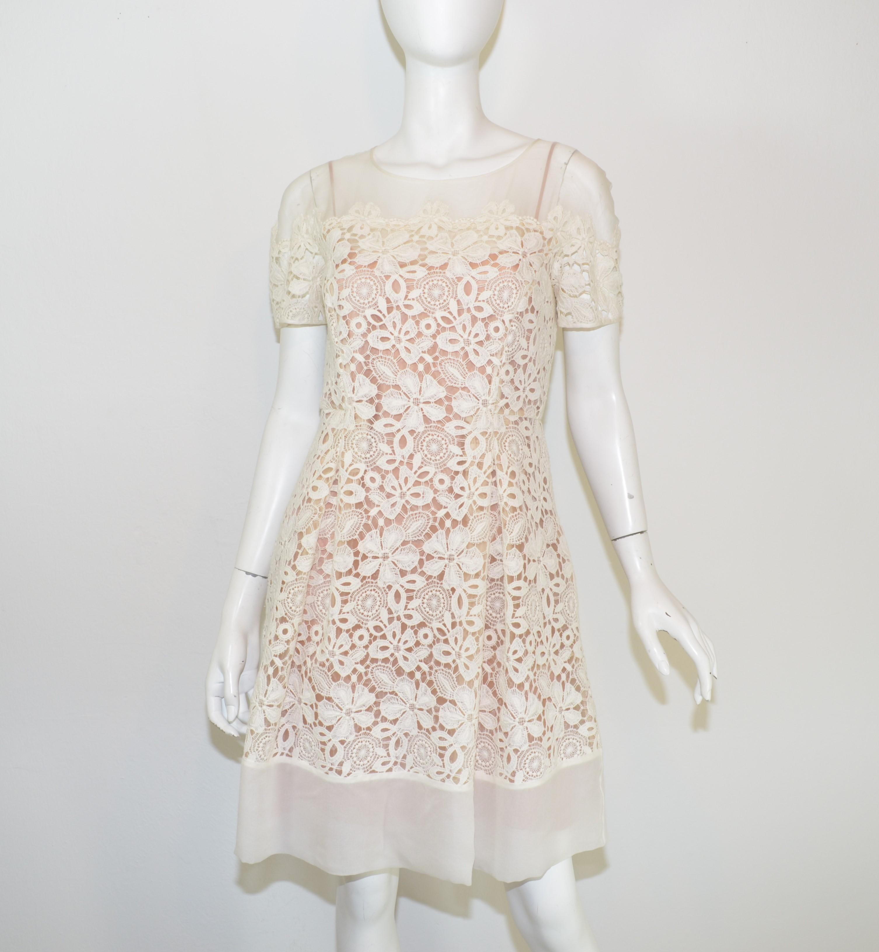 Alberta Ferretti Embroidered Organza A-Line Dress with Flower Motif -- This dress is featured in a cream/ivory embroidery on an organza fabric that has a nude underlayer. Dress has a back neck tie and zipper closure, pockets at the waist, and a full